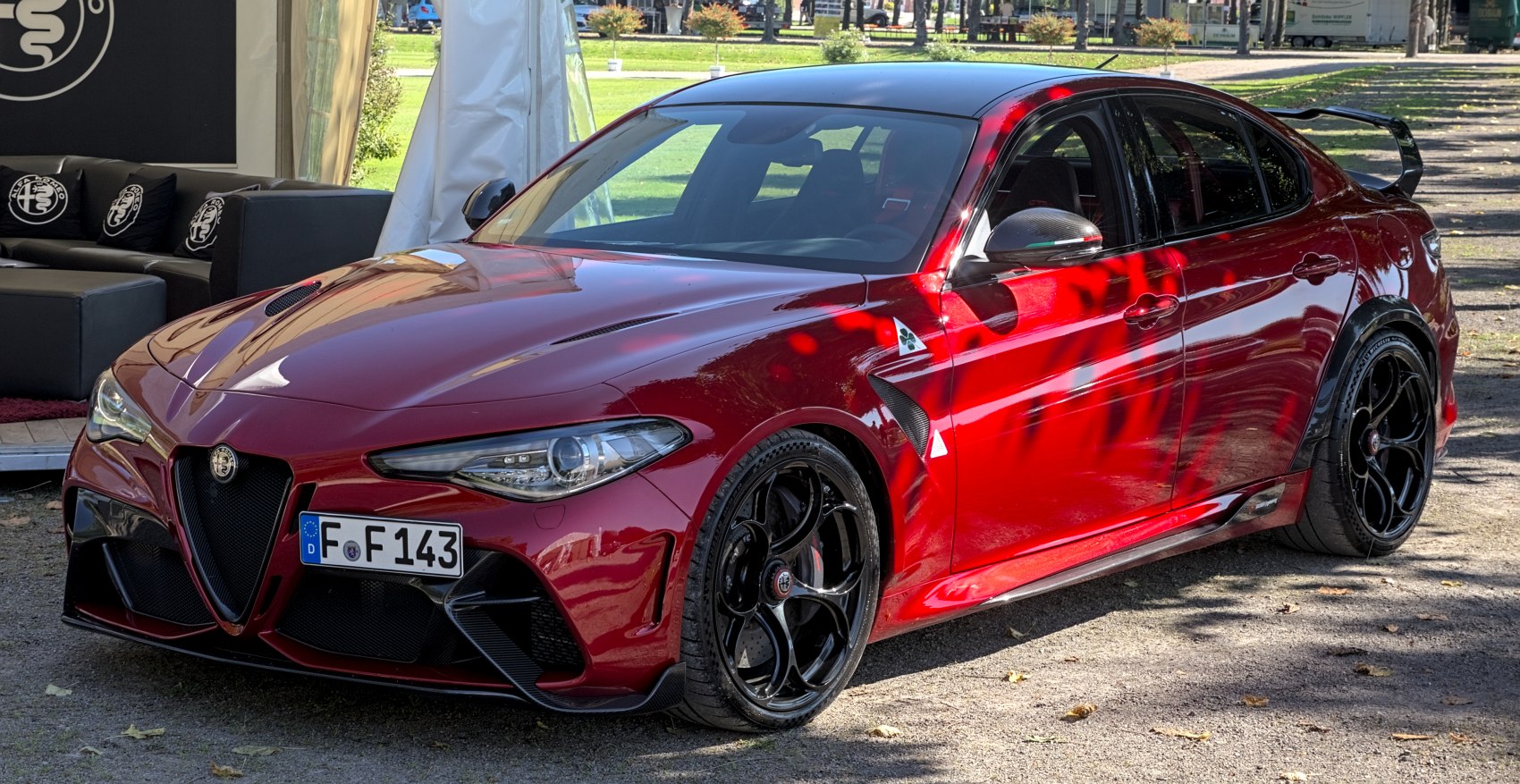 Red sports sedan with rear spoiler and black alloy wheels