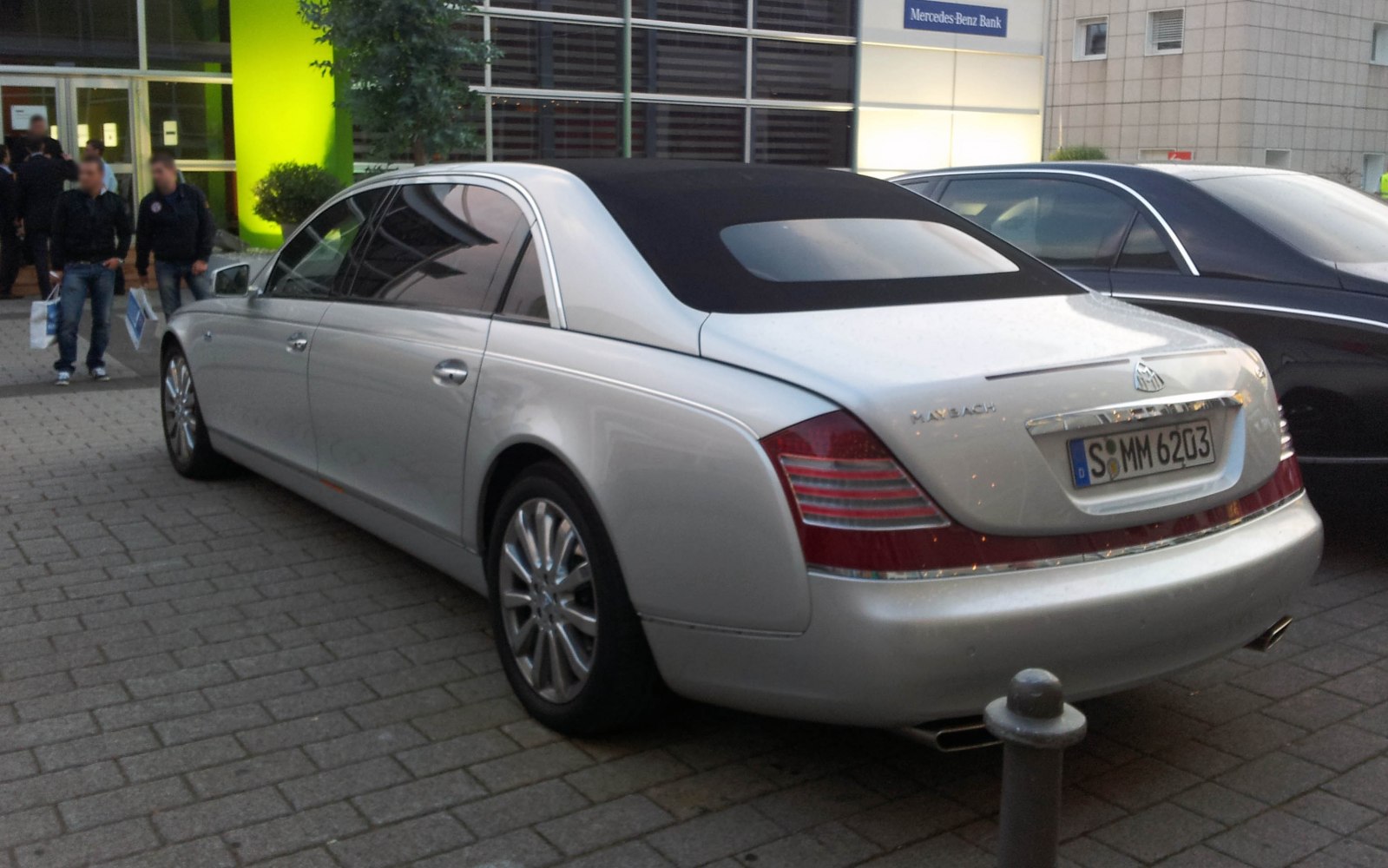 Silver luxury sedan rear with soft top roof and elegant design