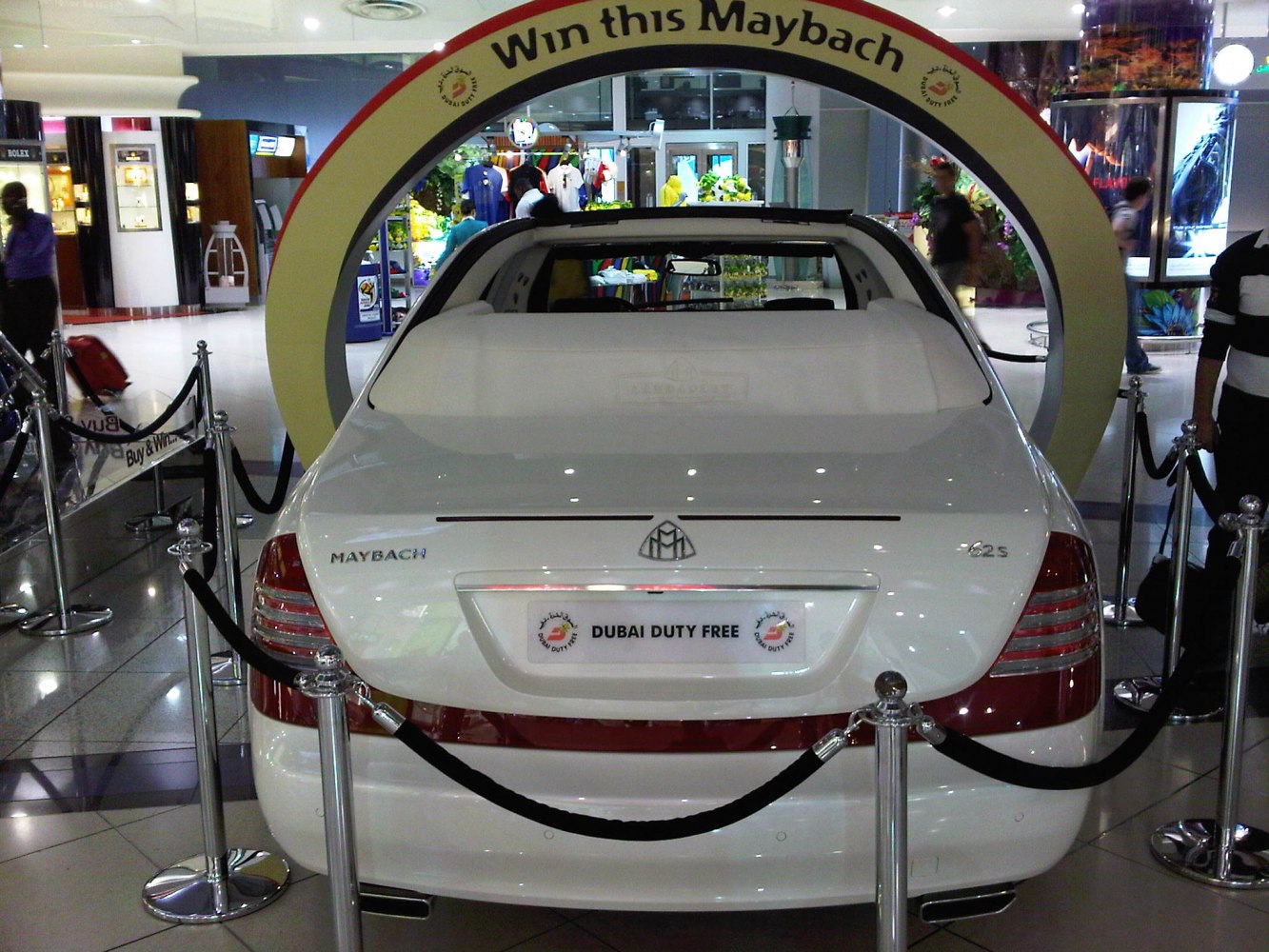 Rear view of luxury car with open roof section and distinctive badge