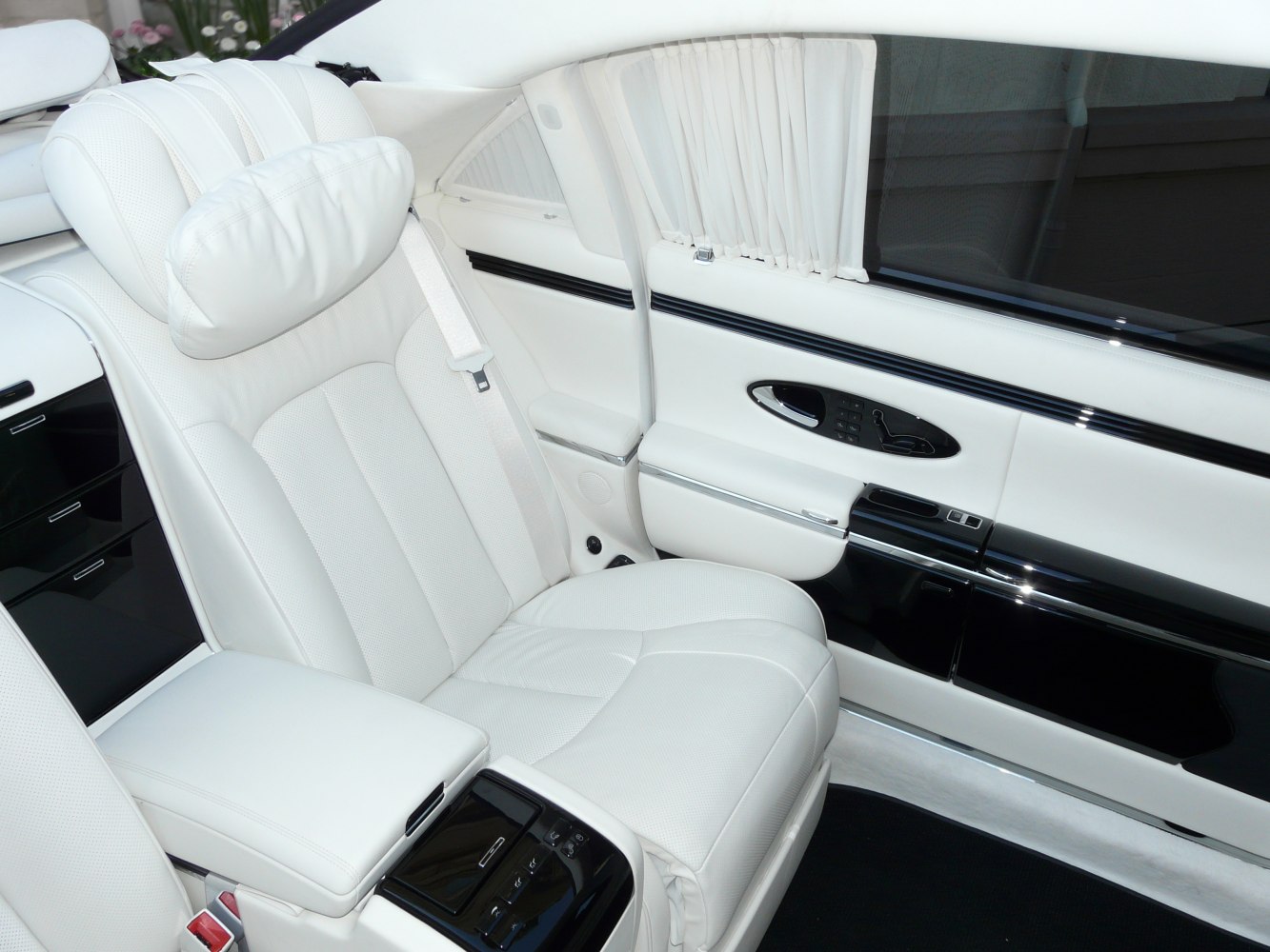 White leather rear seat with control panel and seatbelt