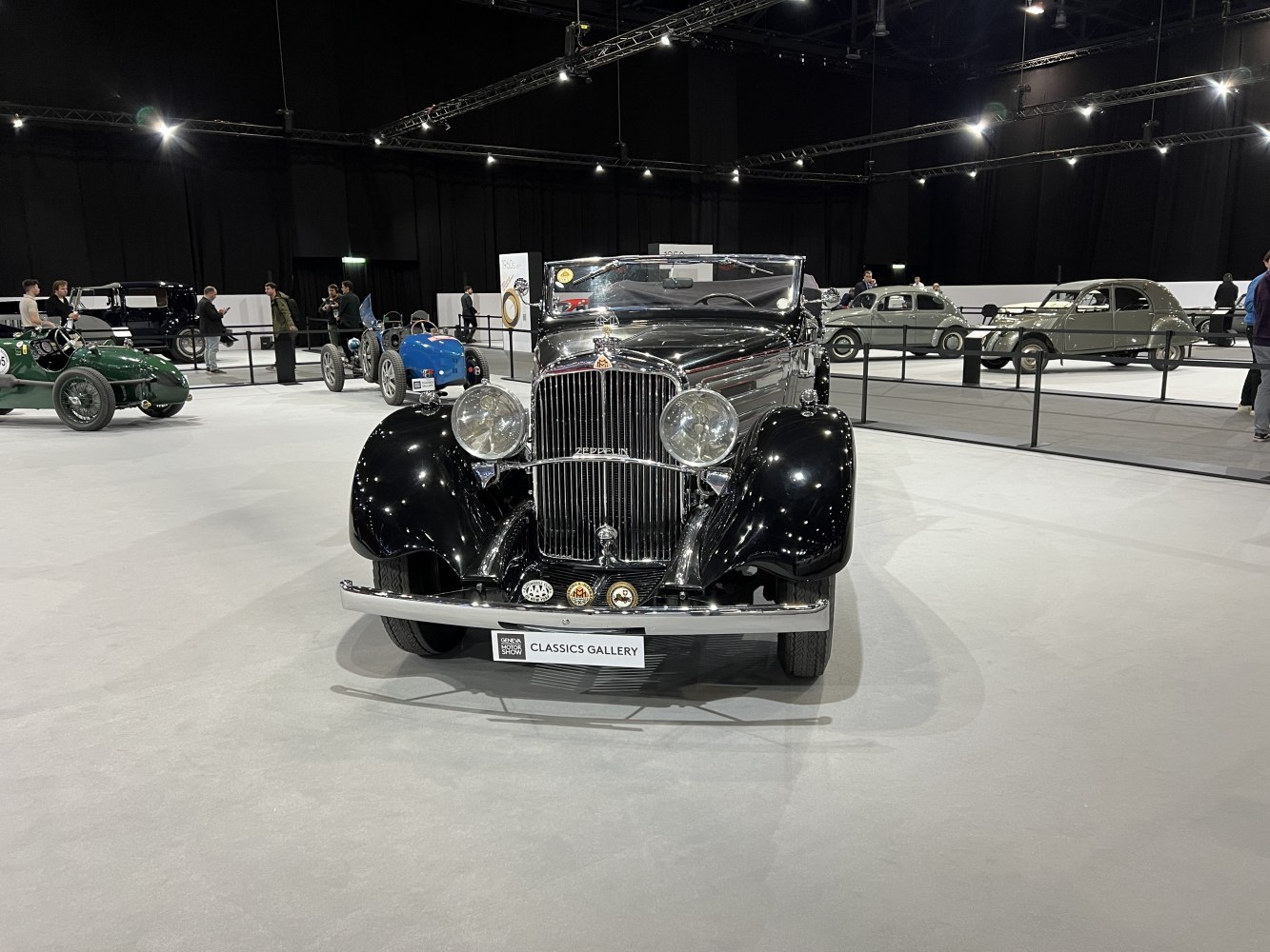 Front view of vintage convertible with large round headlights and chrome grill