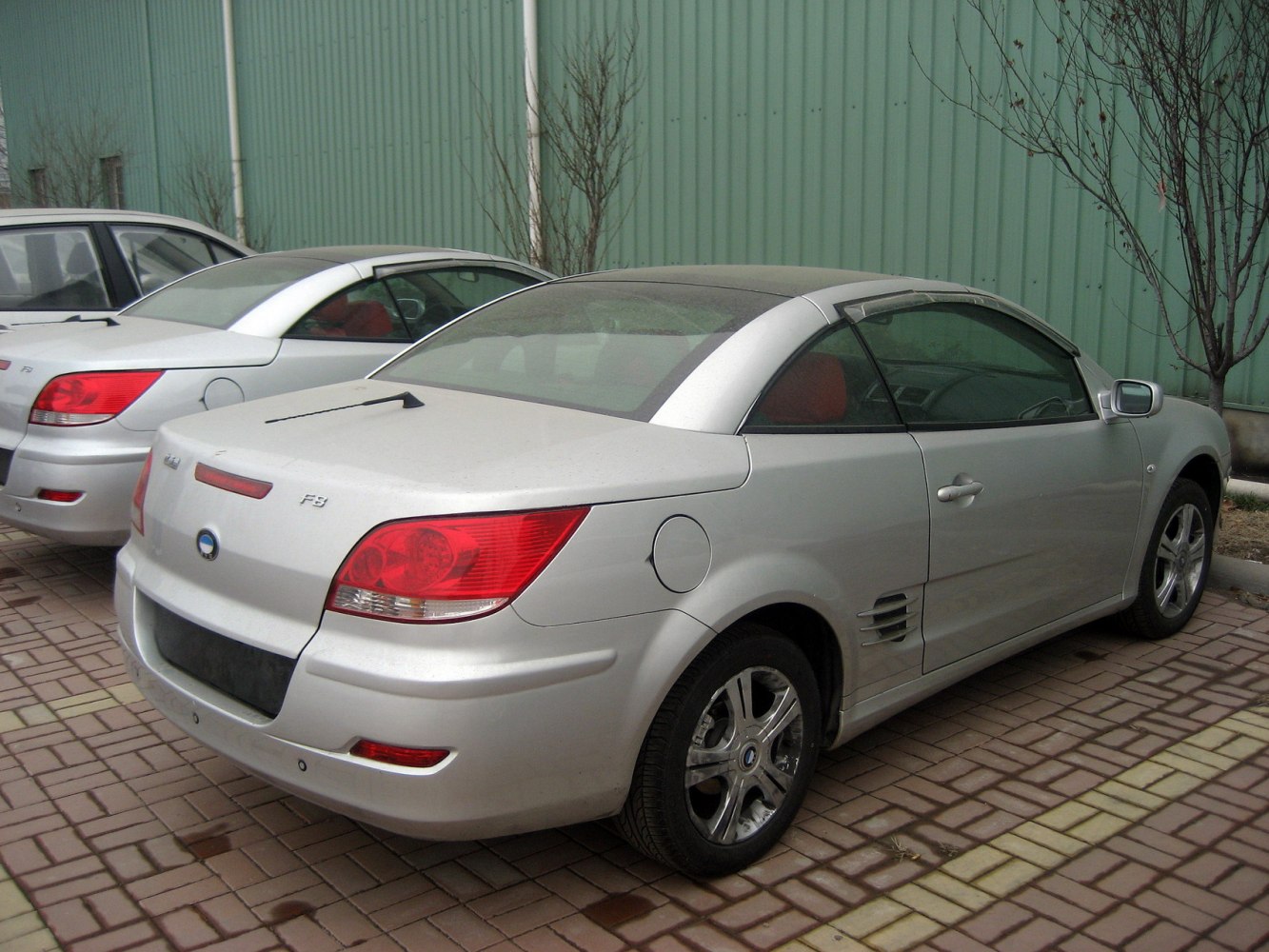 Compact silver convertible showing rear and side design with alloy wheels