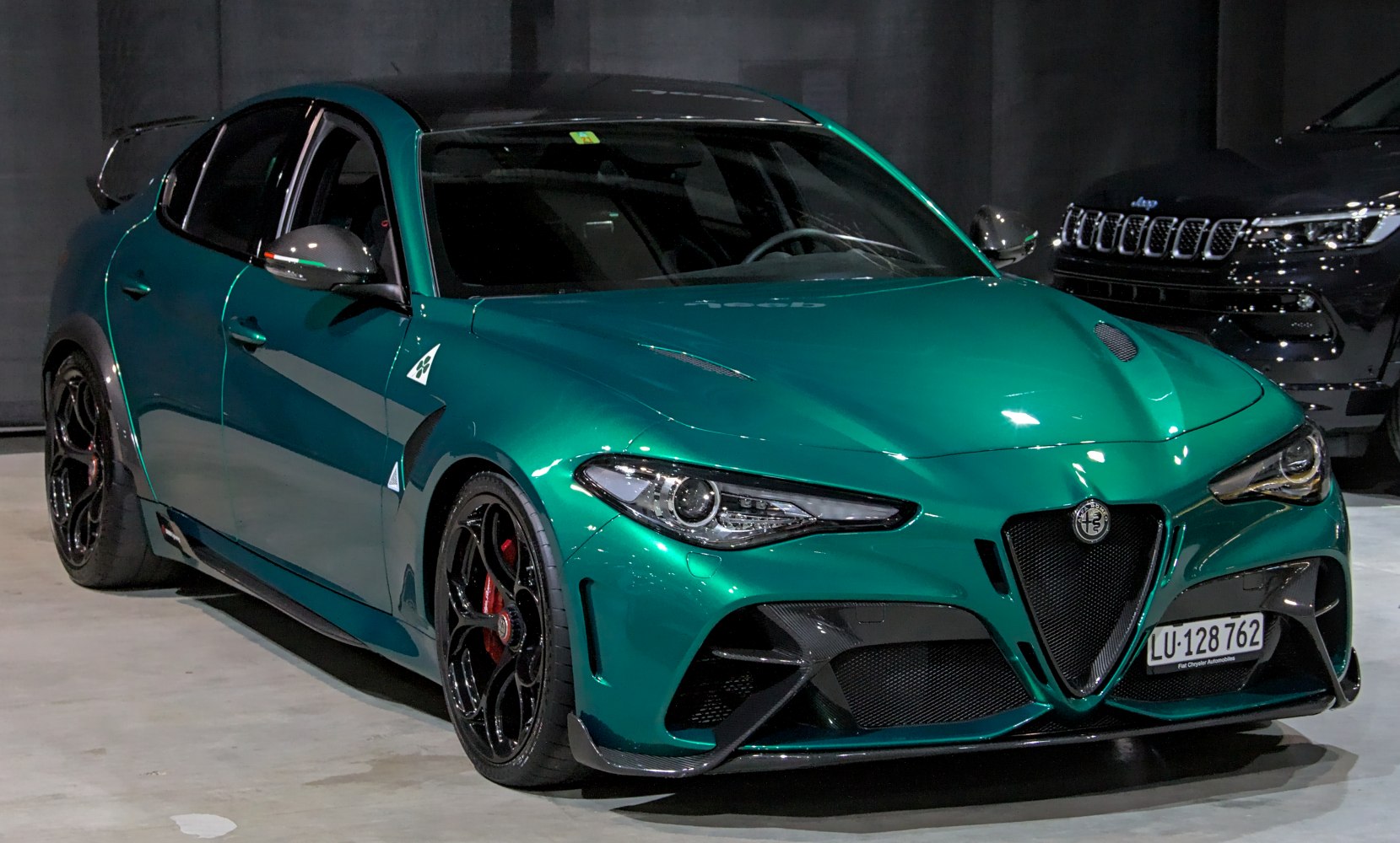 Aerodynamic sports sedan with carbon fiber accents and aggressive front design
