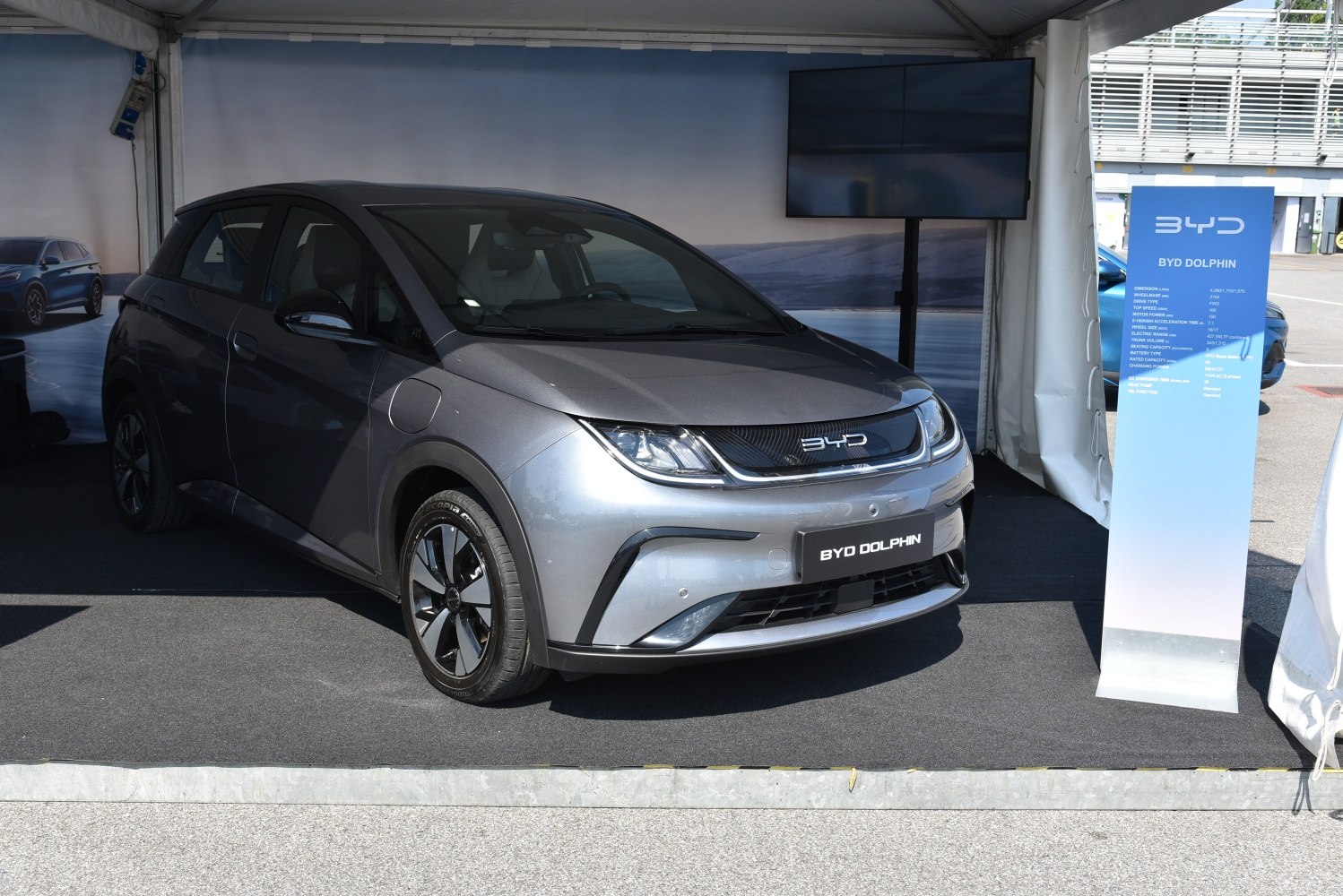 Front angle view of a modern electric hatchback in display setting