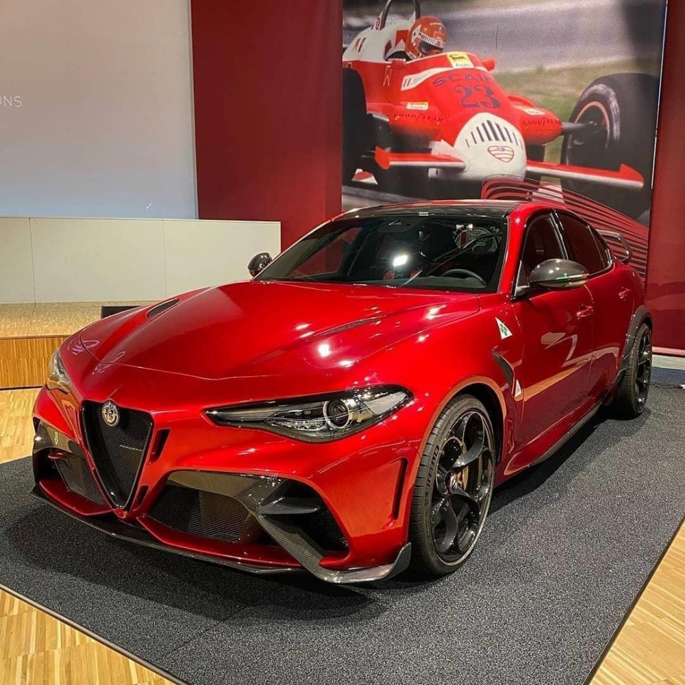 Sporty red sedan with aggressive front and carbon fiber details