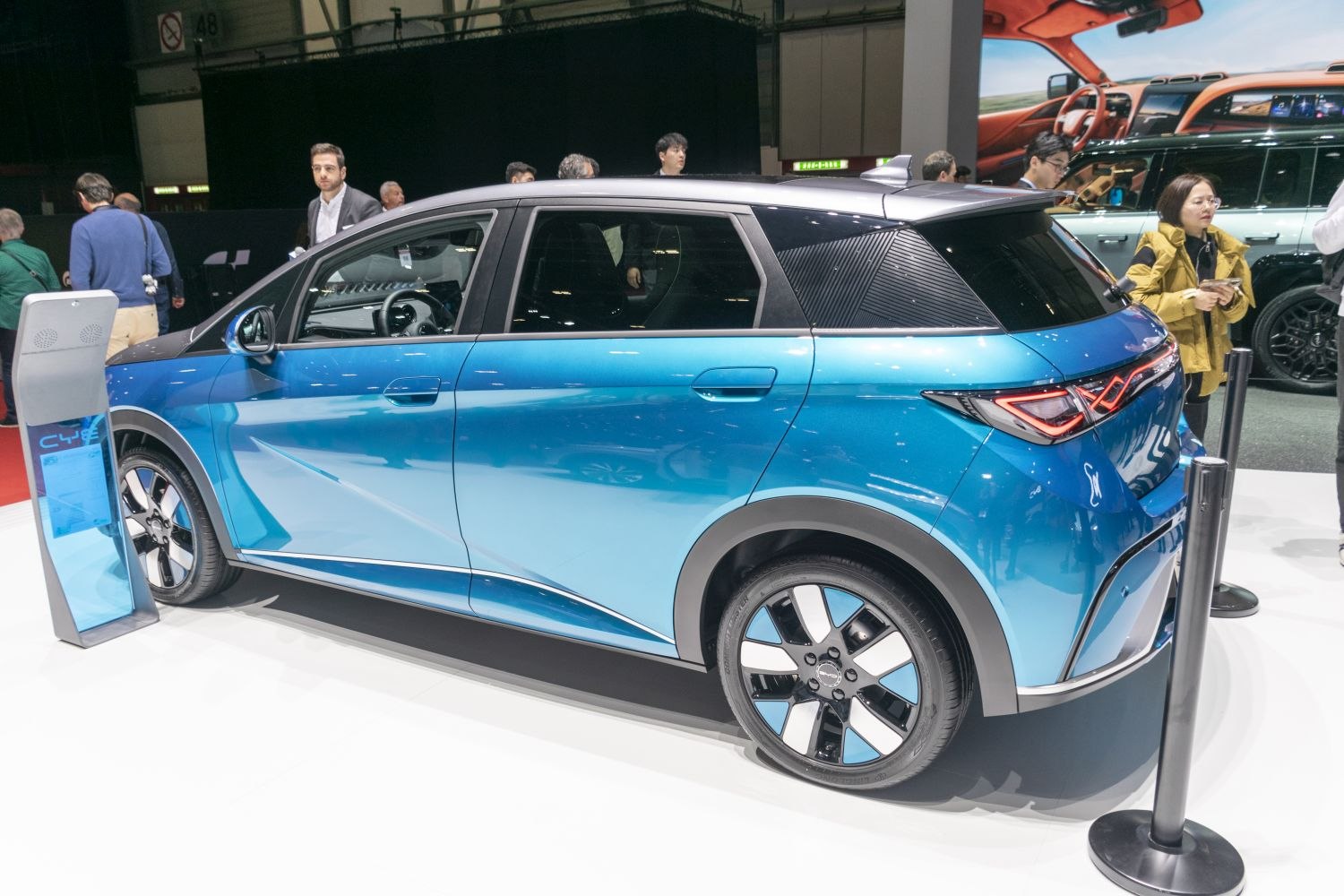 Side profile of electric hatchback with distinct taillight design and two-tone blue body.