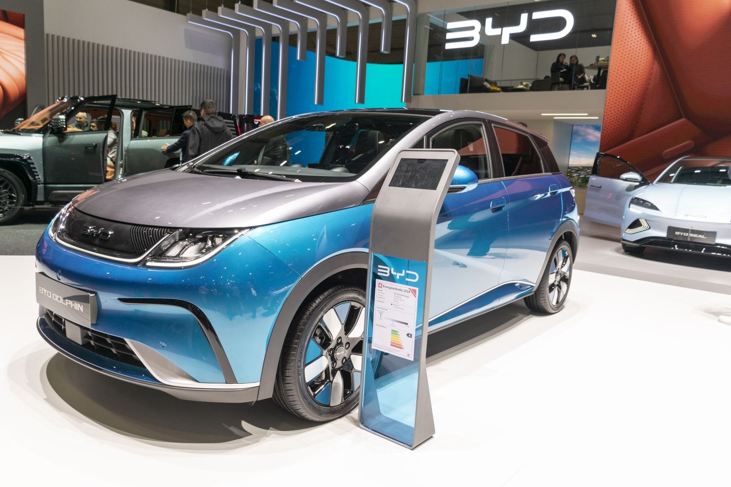 Front side view of a two-tone electric car with sleek headlights