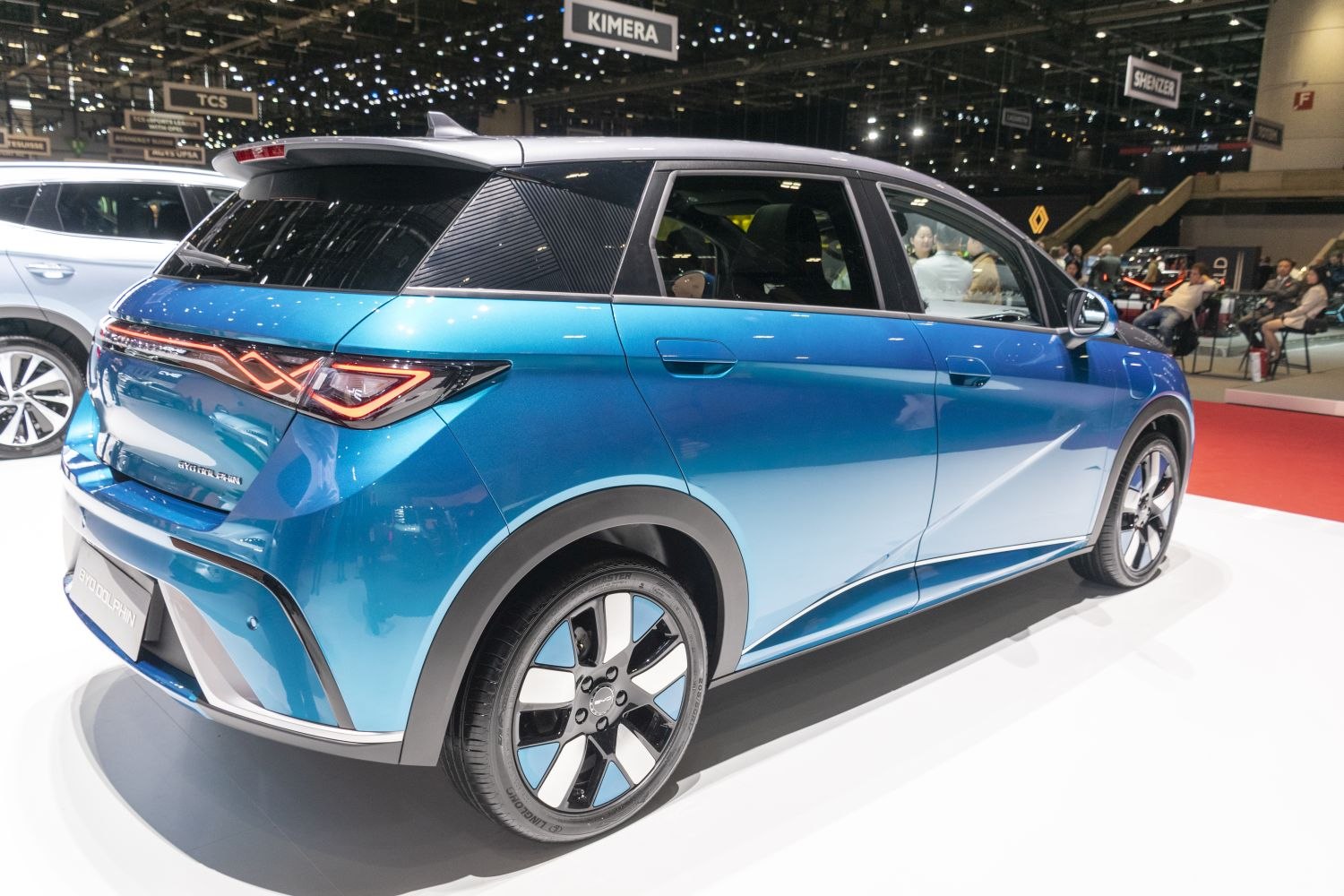 Aerodynamic rear-side view of blue electric hatchback with LED taillights