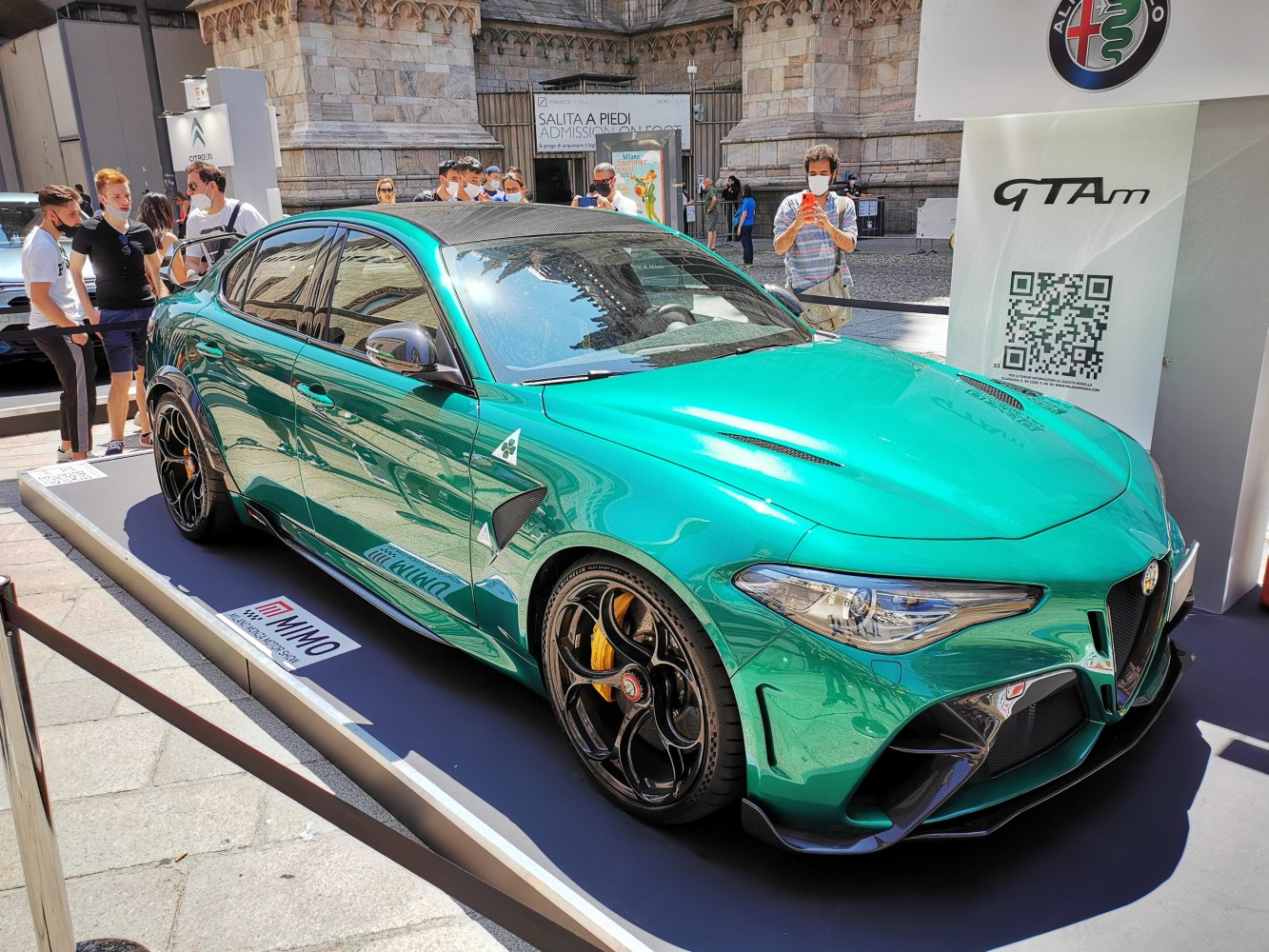 Green high-performance sedan with aggressive aerodynamics and black wheels
