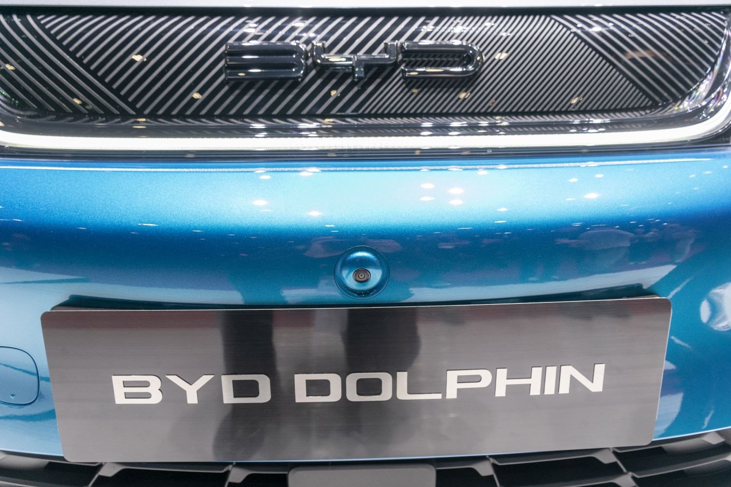 Close-up of front grille with BYD logo and license plate on blue car front