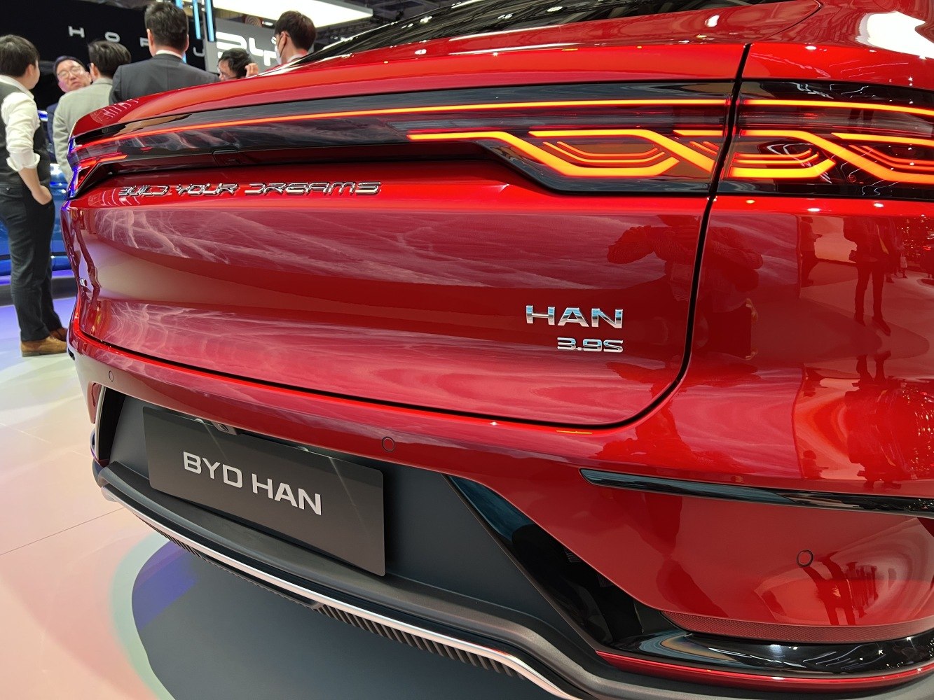 Rear LED taillight and badge design on red car rear