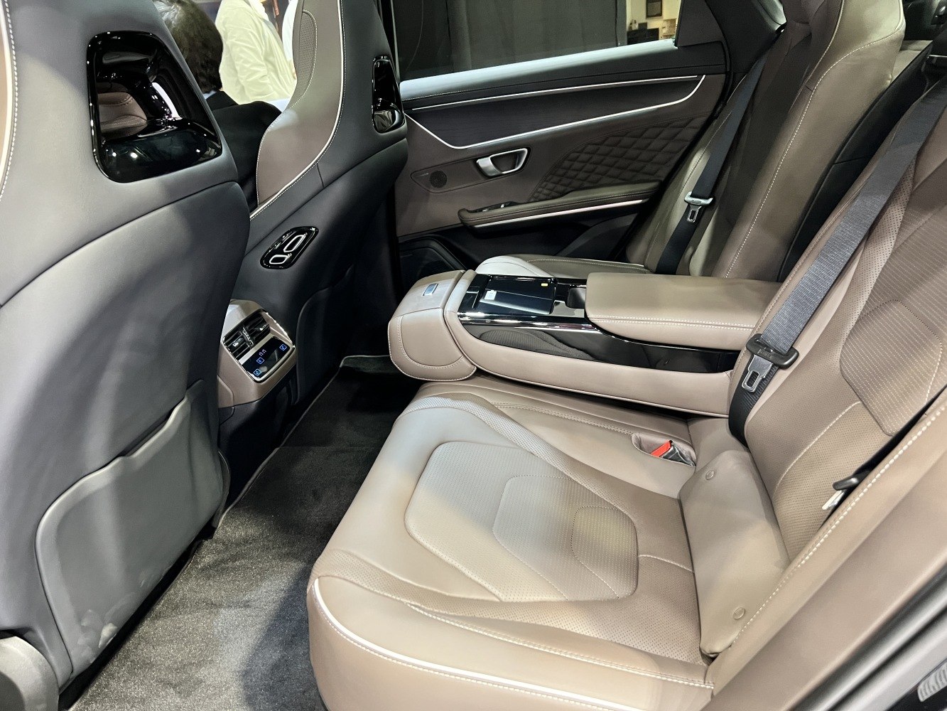 Luxury rear seat interior with leather upholstery and center armrest console