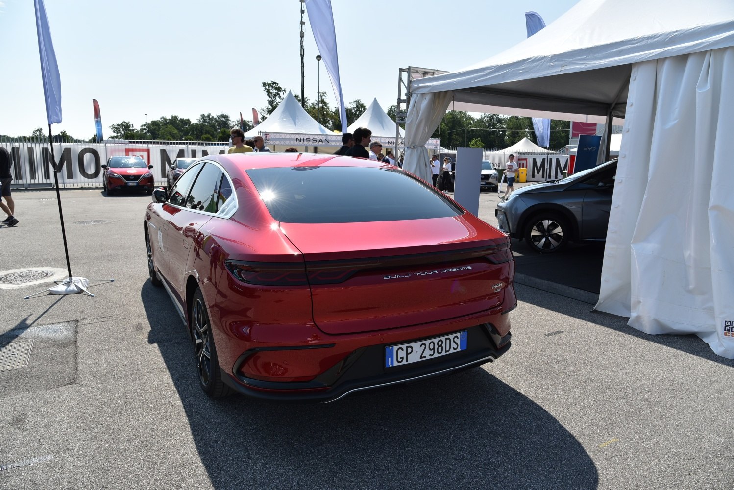 Sleek rear view of a modern electric sedan with distinctive taillights and aerodynamic design.