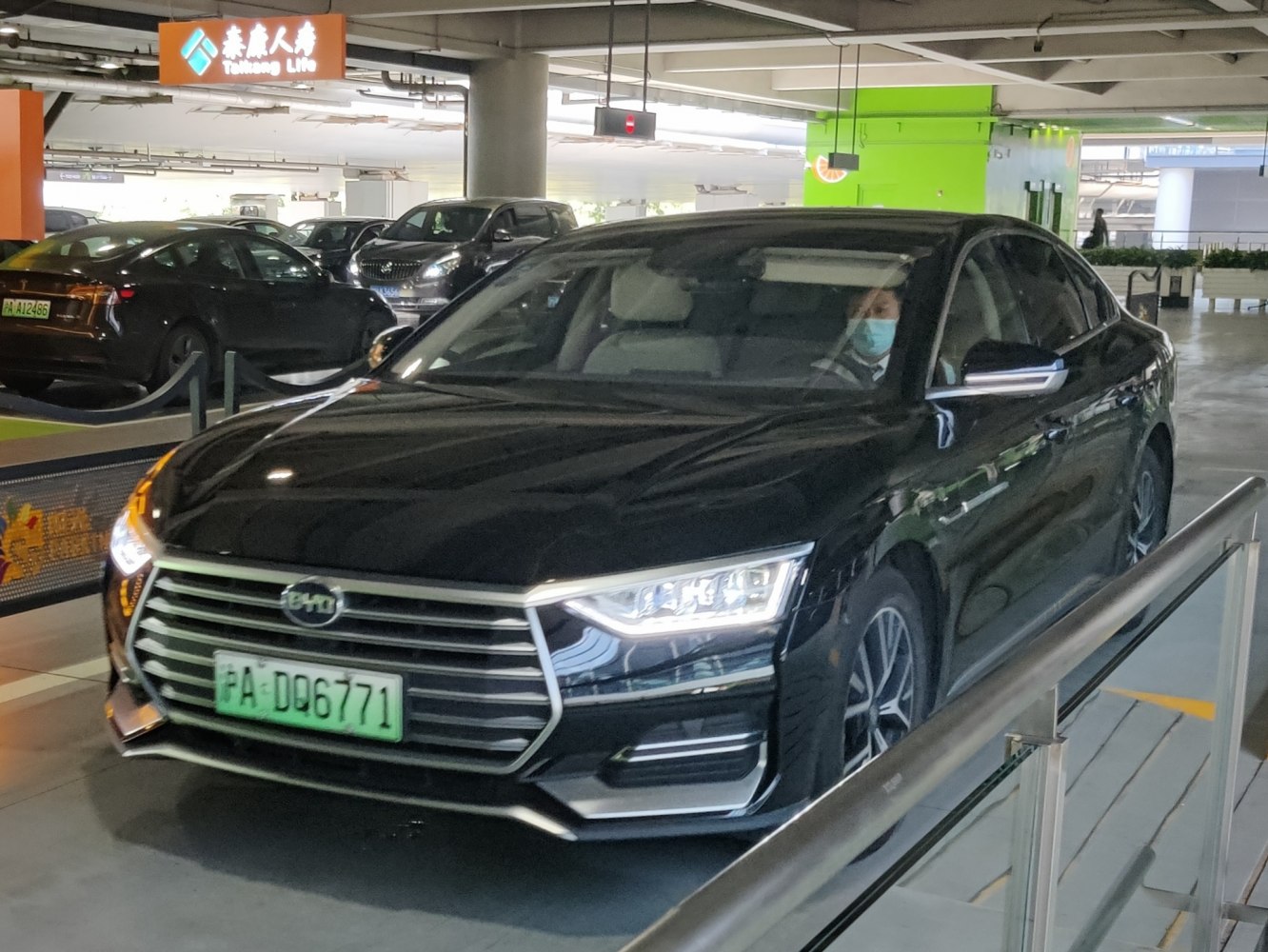 Front grille and LED headlights of a sleek black sedan.