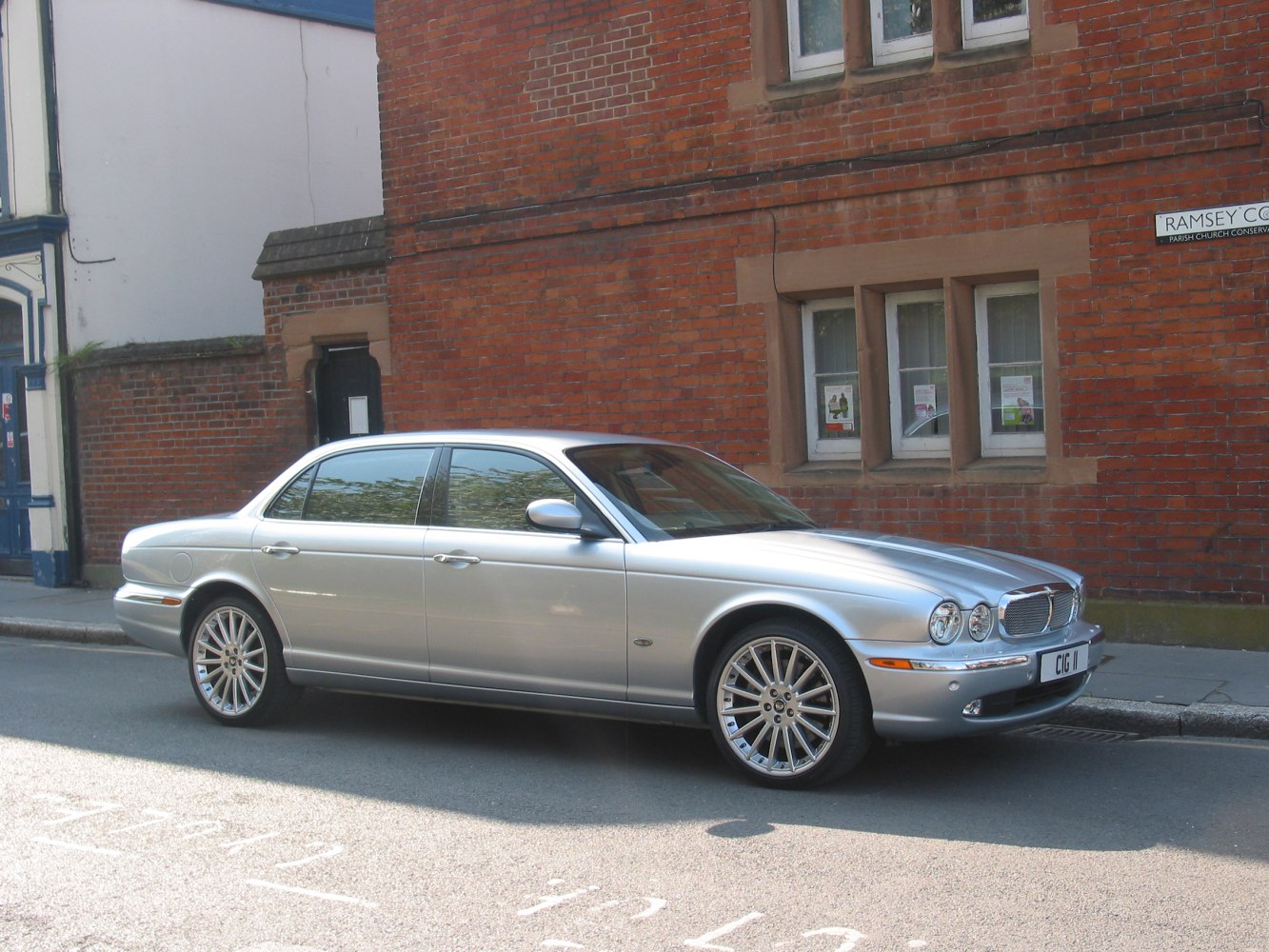 Silver luxury sedan with round headlights and chrome grille