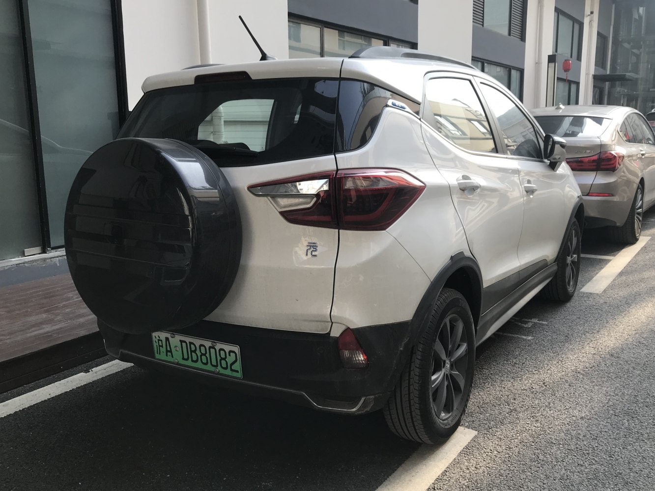 Rear view of compact SUV with mounted spare tire and taillights