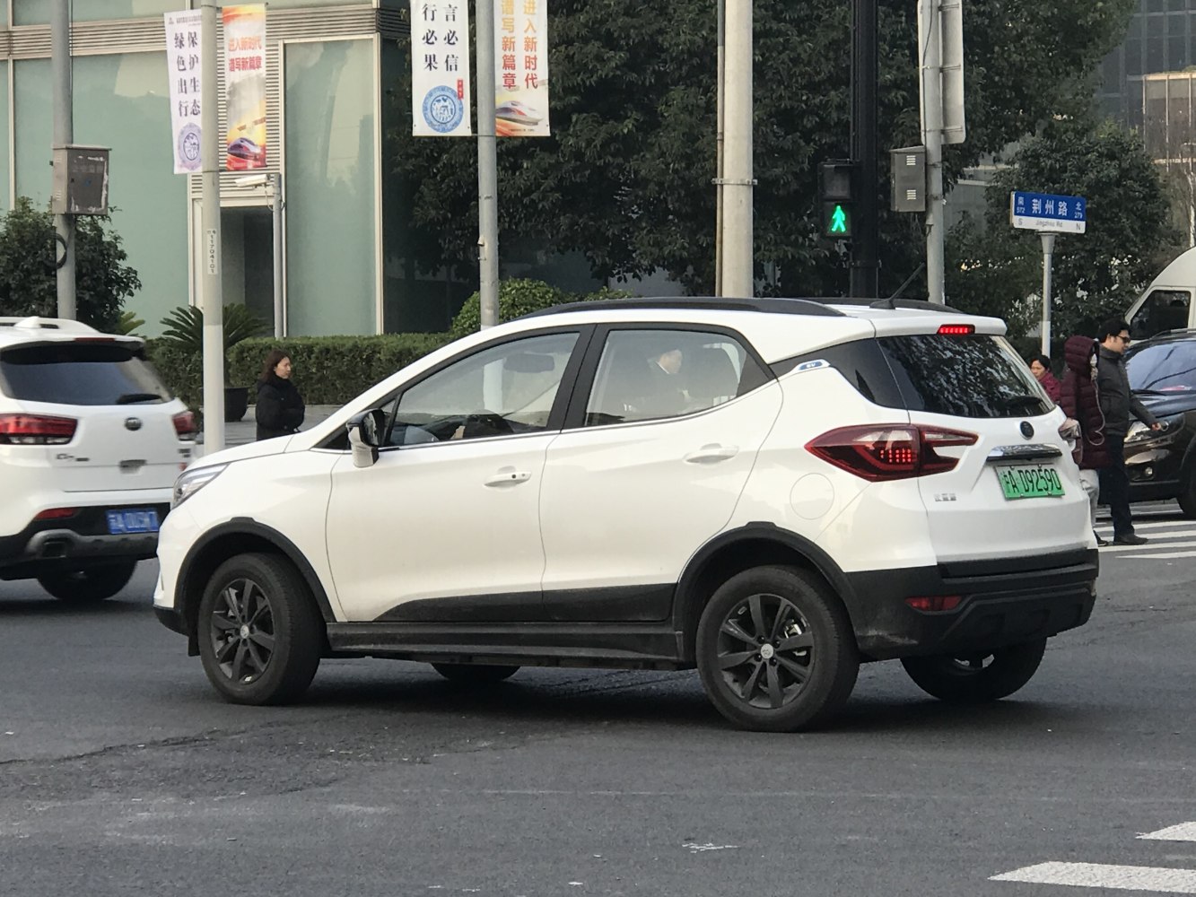 White electric SUV side view with black wheels and rear taillights