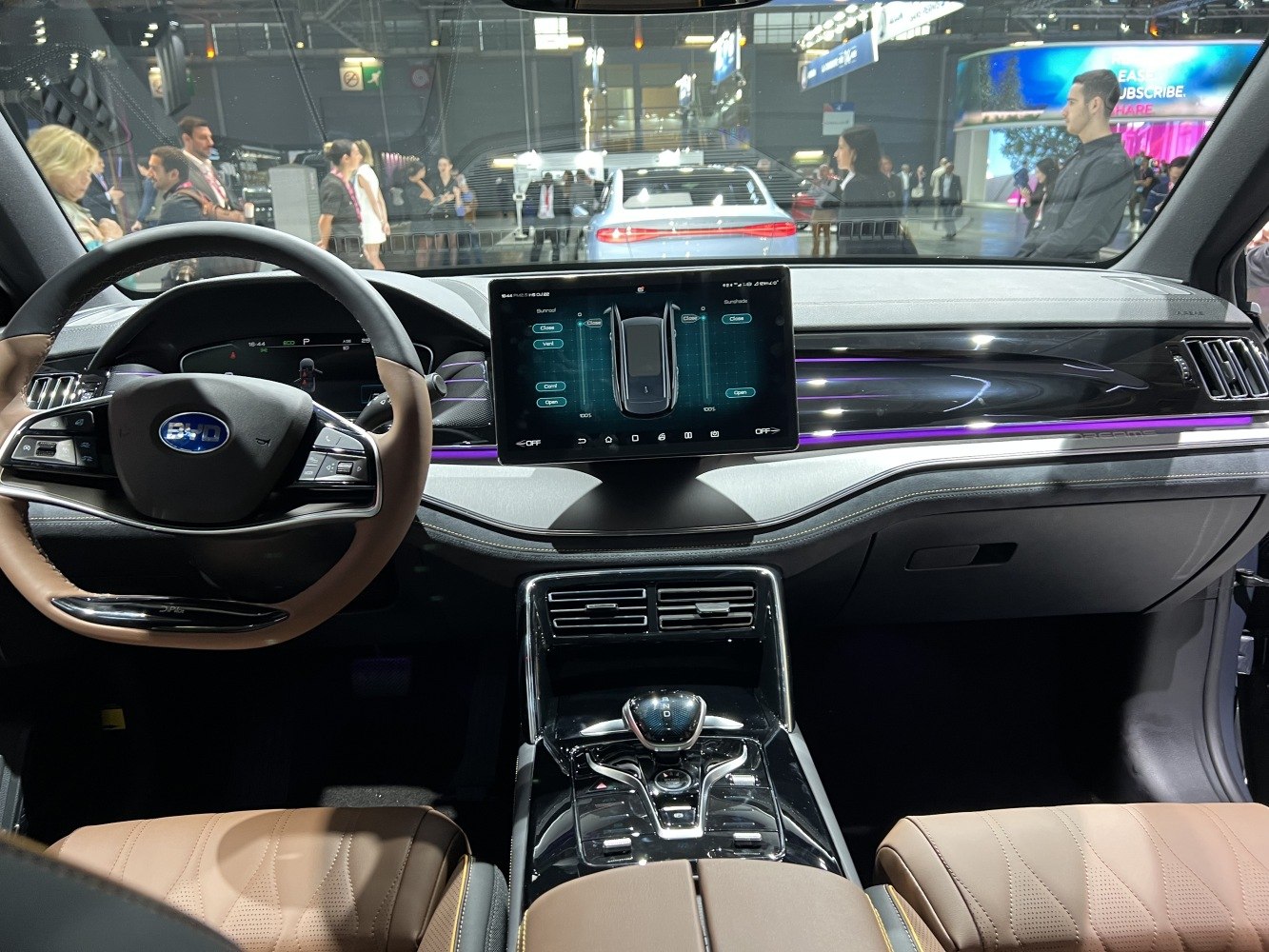 Luxury dashboard and steering wheel with digital touchscreen and brown leather seats