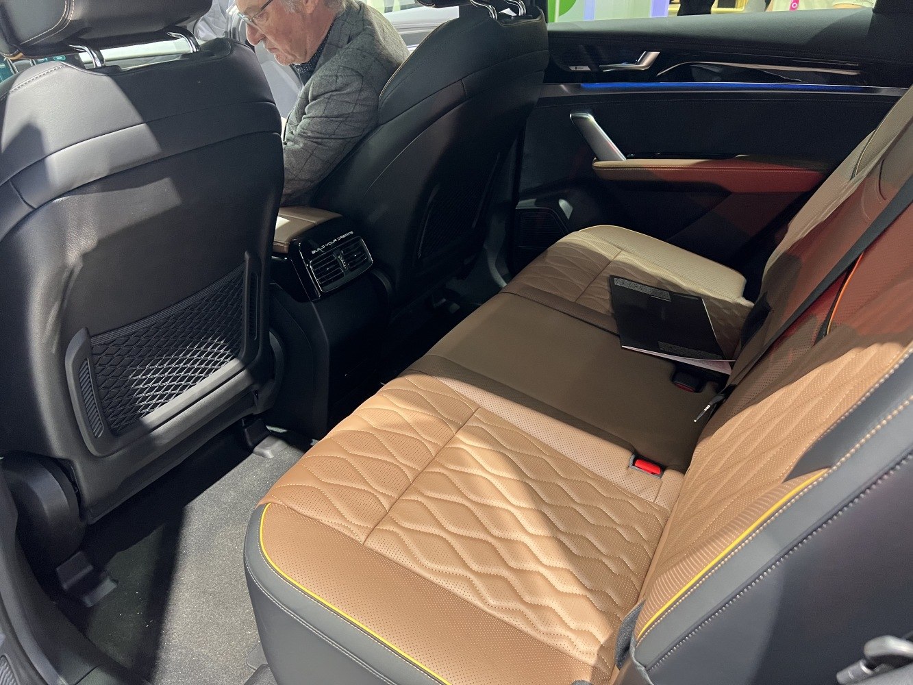 Quilted brown leather rear seats with spacious black interior and rear air vents