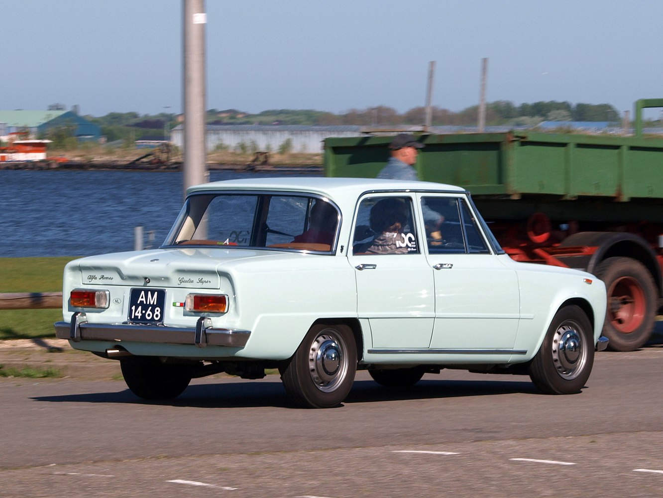 Rear side view of classic 1960s vintage four-door sedan with boxy design.
