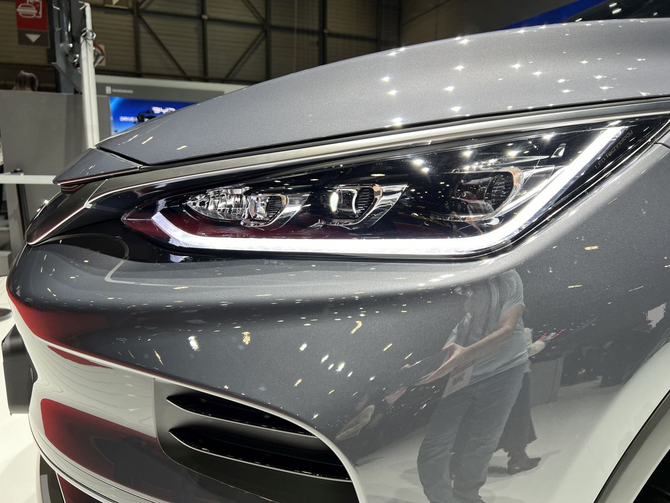 Close-up of a modern LED headlight with surrounding front panel.