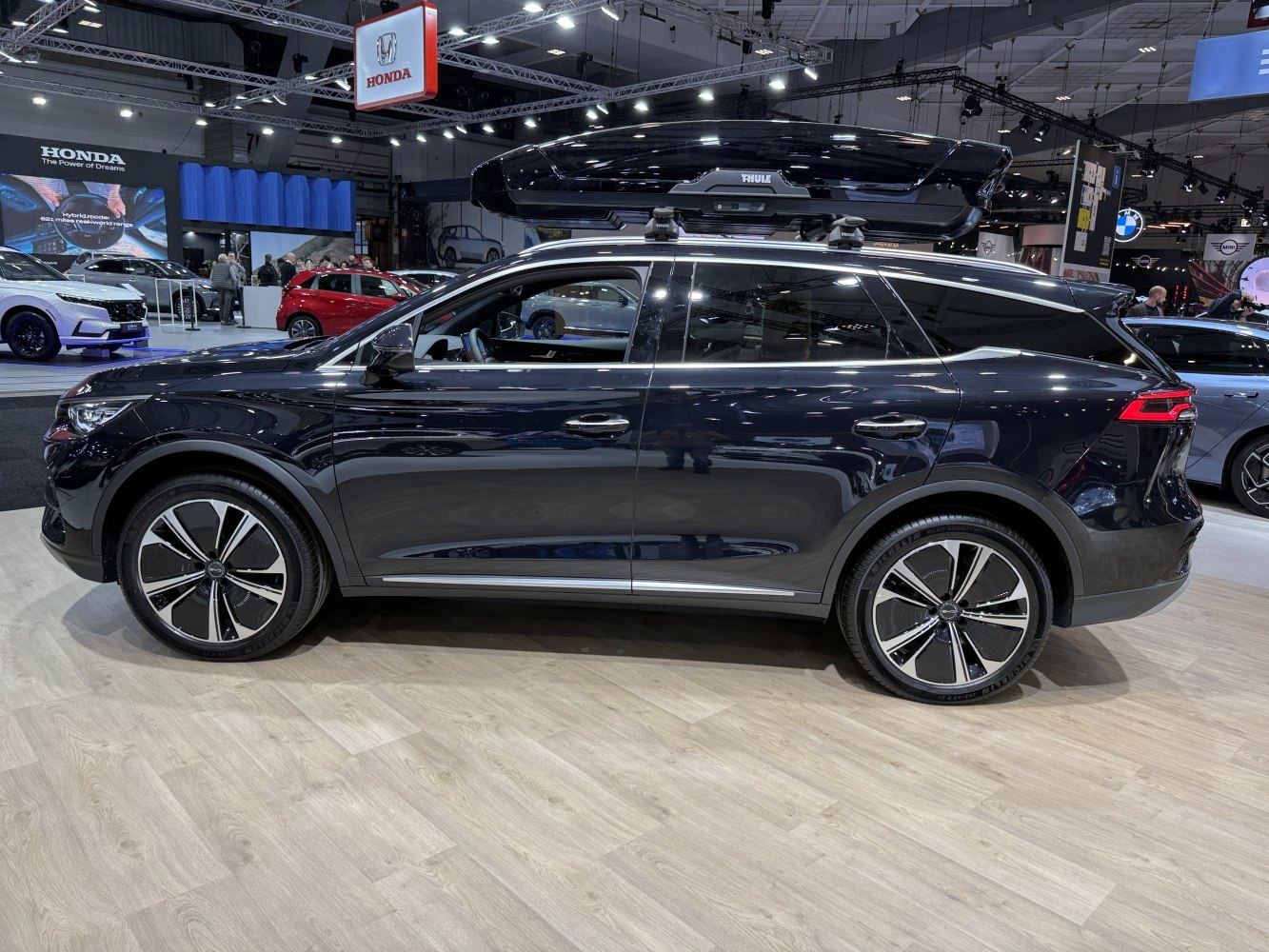 Side profile of SUV with roof cargo box and modern alloy wheels