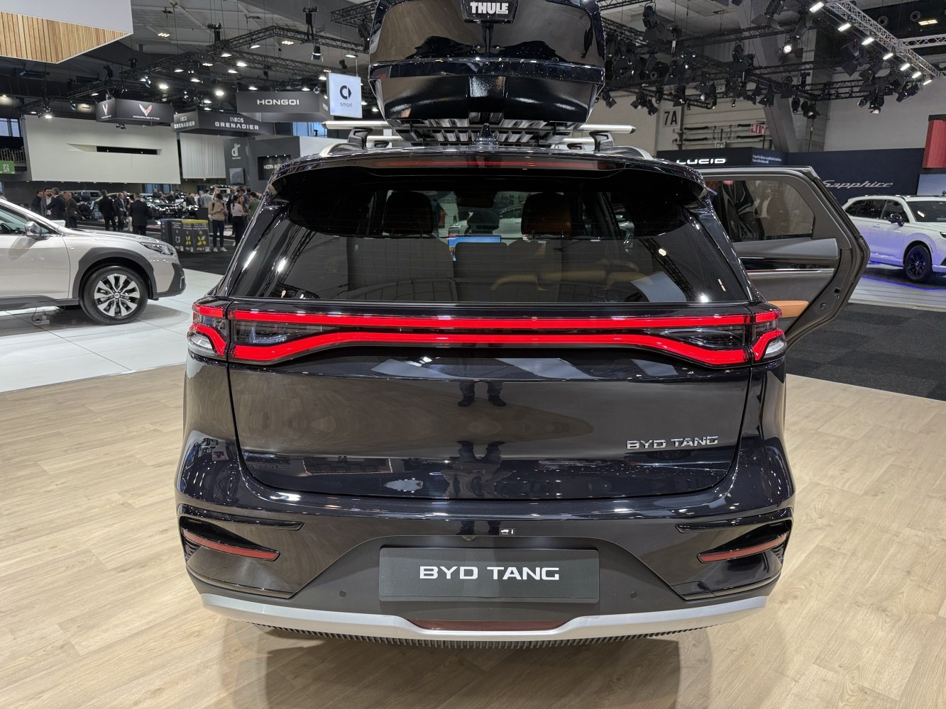 Rear of SUV with continuous LED tail light strip and roof-mounted cargo box