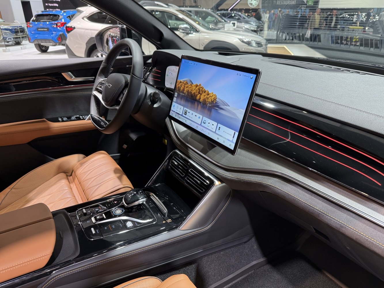 Large infotainment touchscreen and modern car interior with brown leather seats