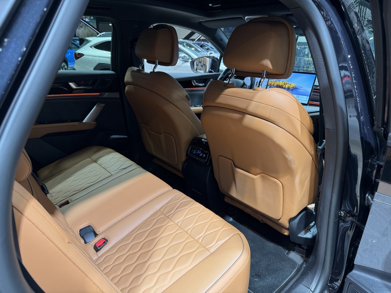 Luxurious tan leather rear seats and spacious car cabin interior