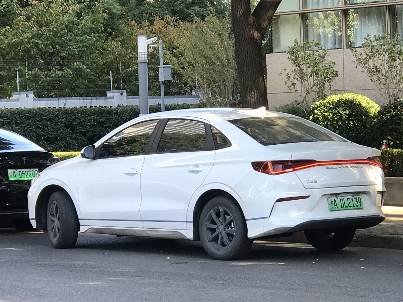 White electric sedan with LED taillights and aerodynamic rear design.