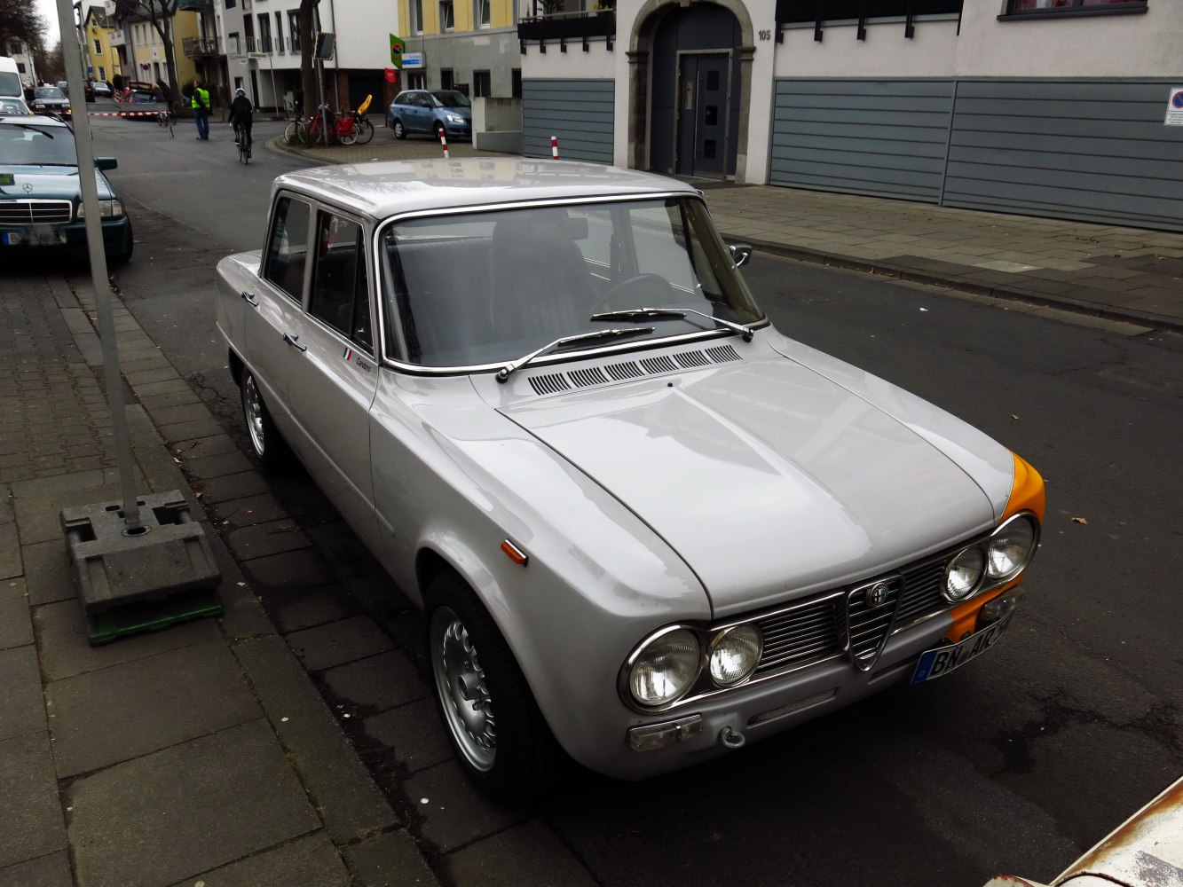 Vintage sedan with dual round headlights and classic grille.