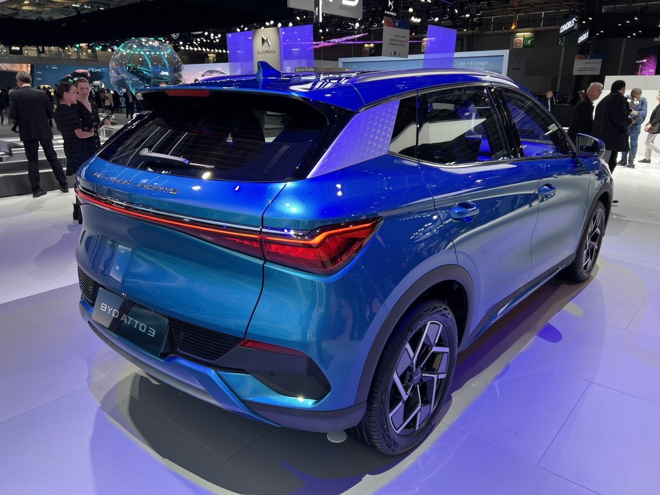 Rear view of a blue electric SUV with LED tail lights and distinct alloy wheels