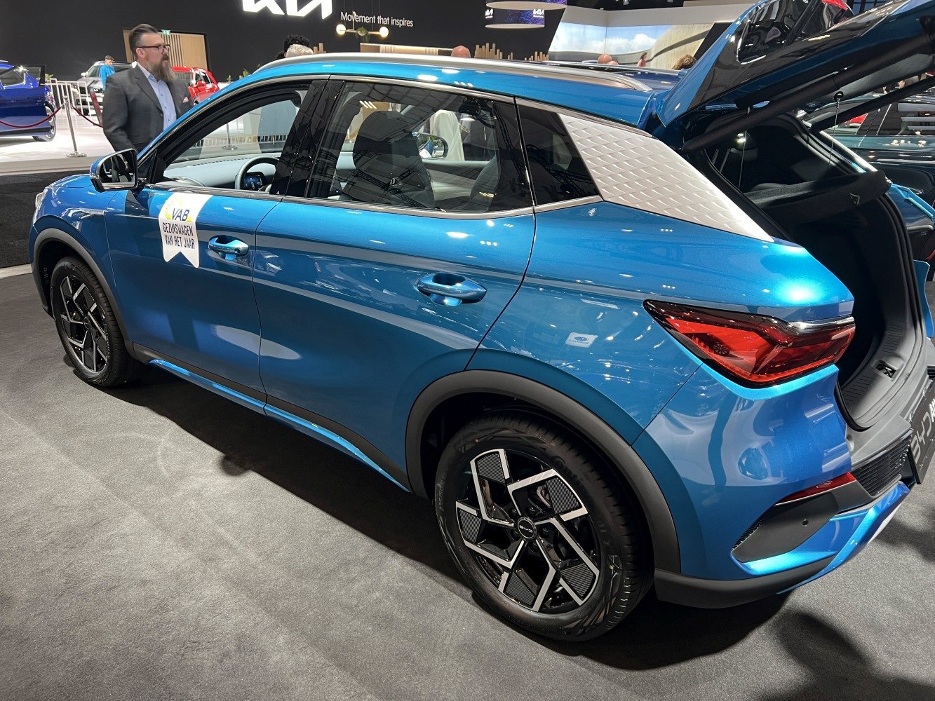 Blue compact SUV side view with textured white C-pillar and alloy wheels