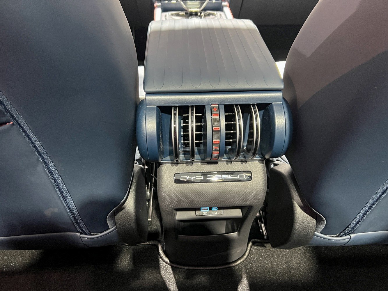 Rear passenger air vents and USB charging ports between car seats