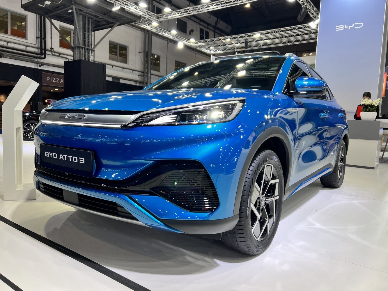 Close-up of front headlight and alloy wheel of modern electric SUV.
