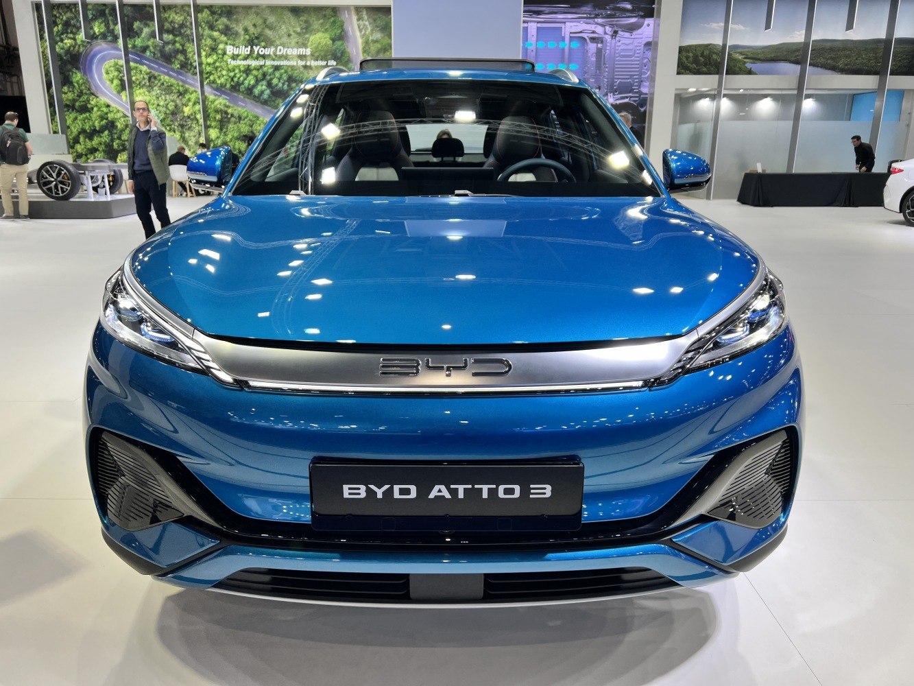 Front view showing LED headlights and aerodynamic grille of blue SUV