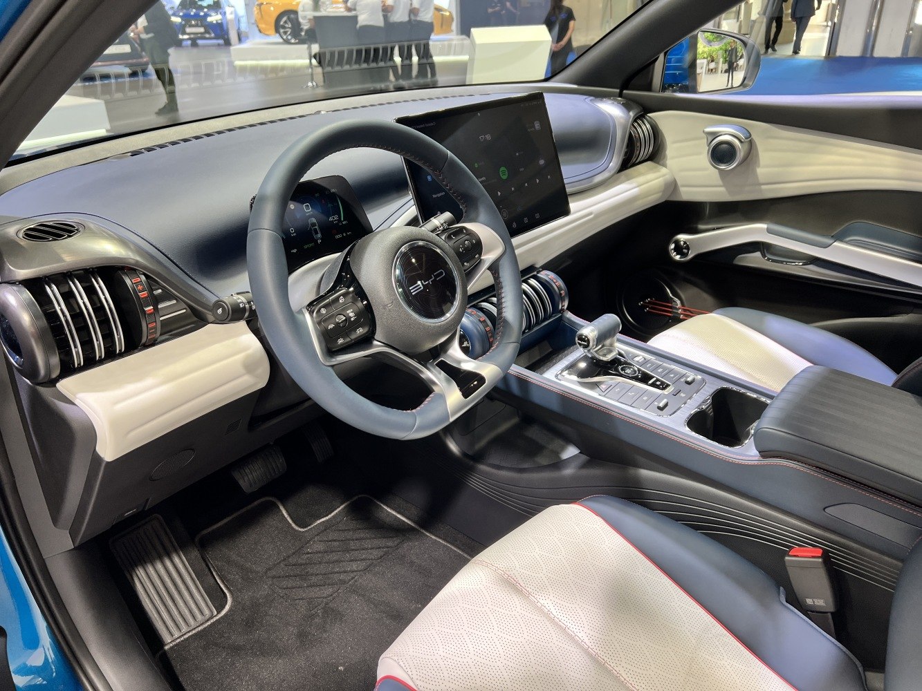 Modern digital dashboard and touchscreen infotainment system with multi-function steering wheel.