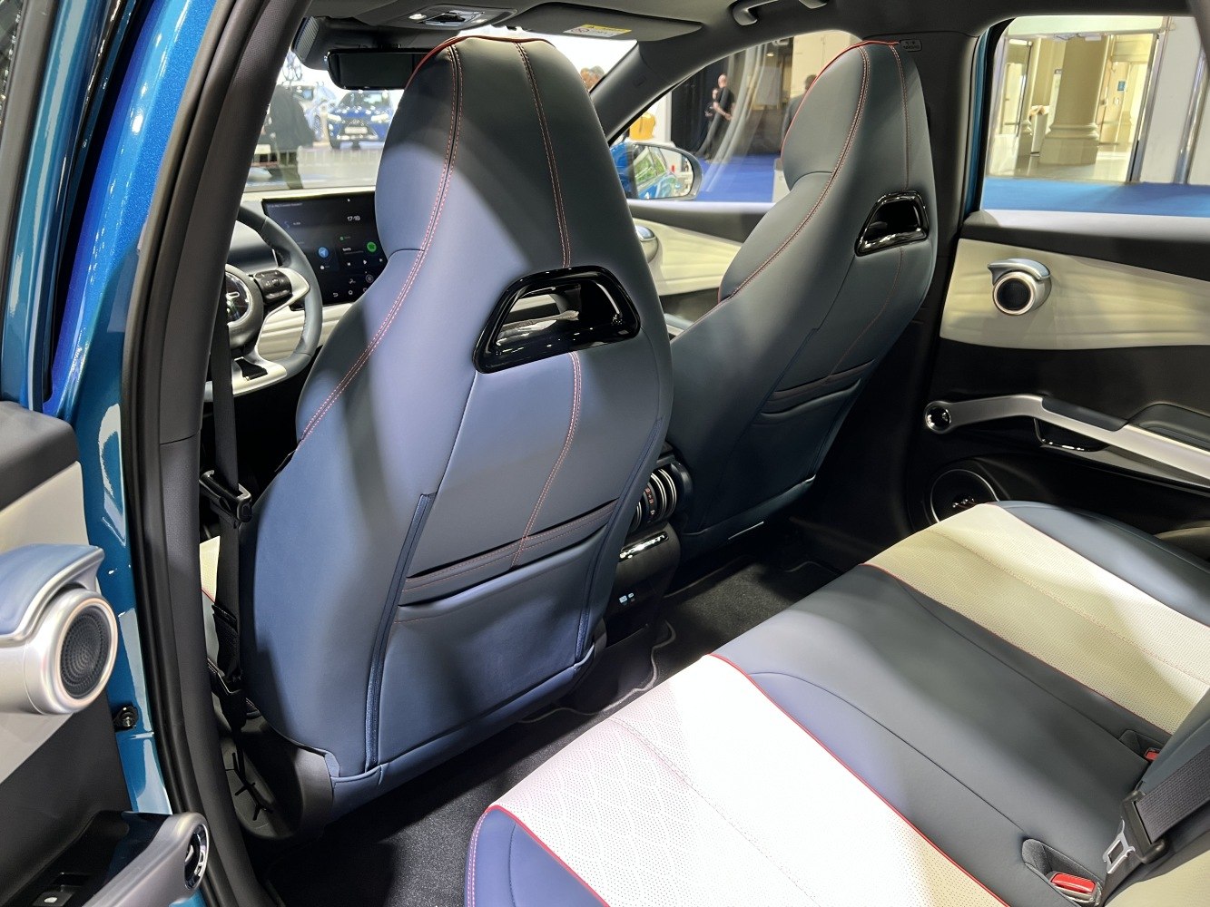 Modern rear seats and interior door panel with sleek design and upholstery.