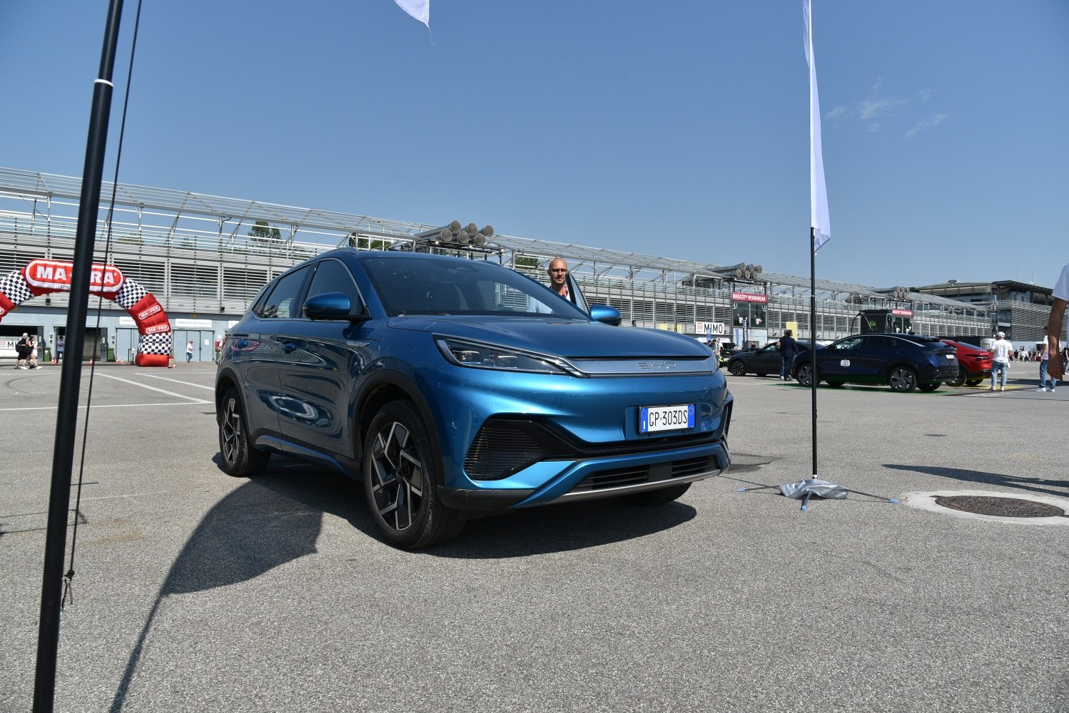 Blue electric SUV front and side view with sleek headlights and aerodynamic styling.