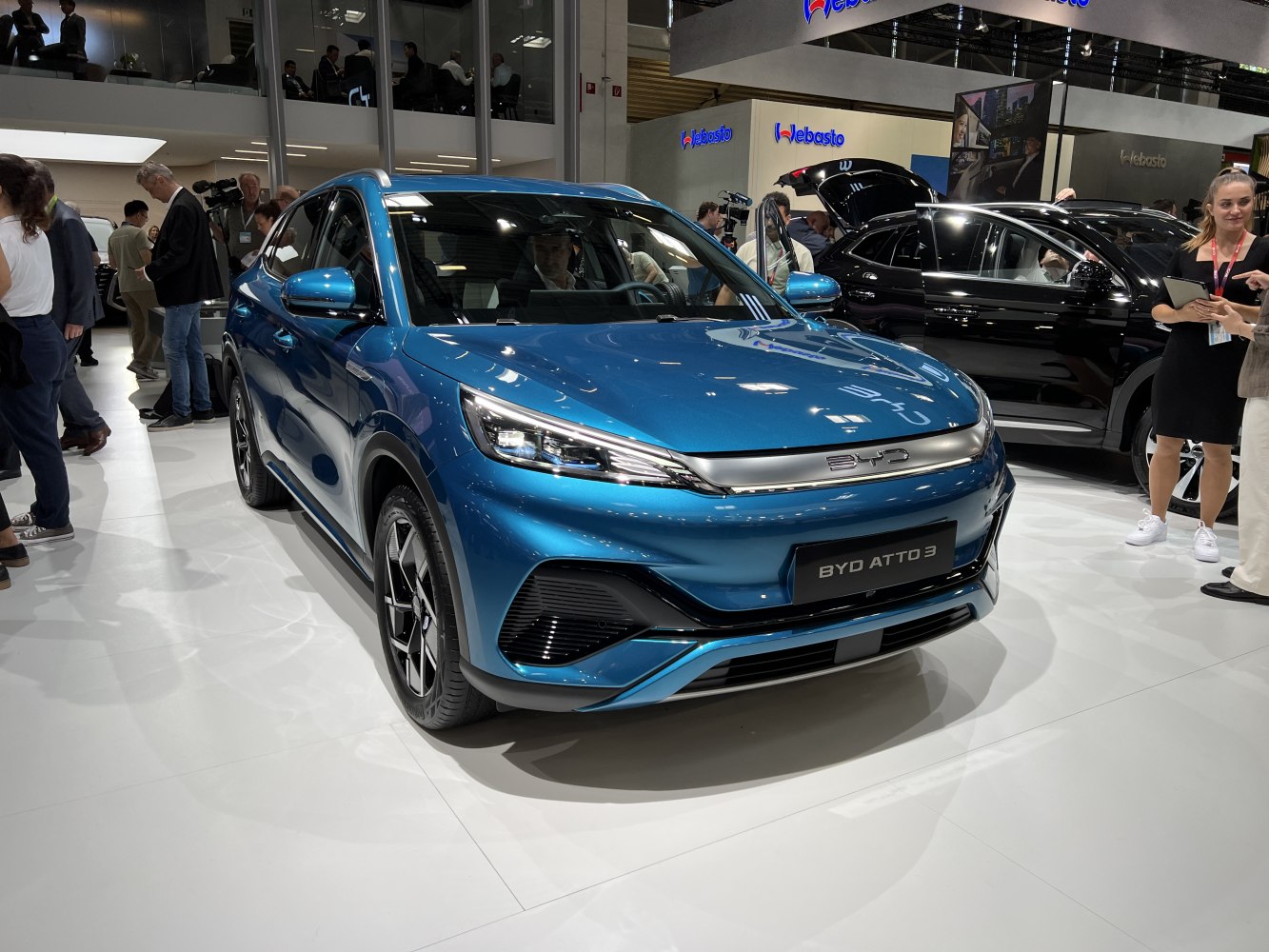 Blue electric crossover SUV front with angular LED headlights and black grille