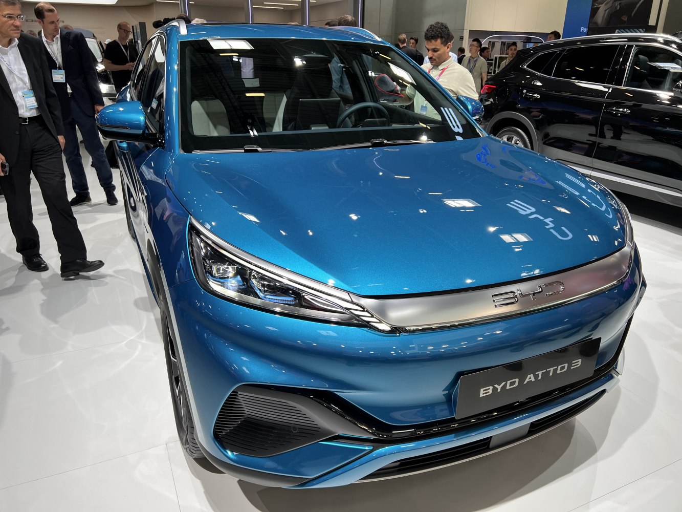Front view of blue electric SUV with LED headlights and modern grille