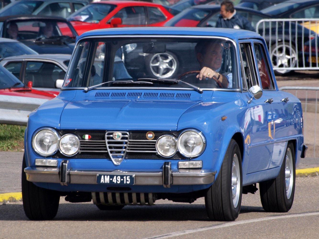 Front view of vintage blue sedan with quad round headlights and distinctive grille