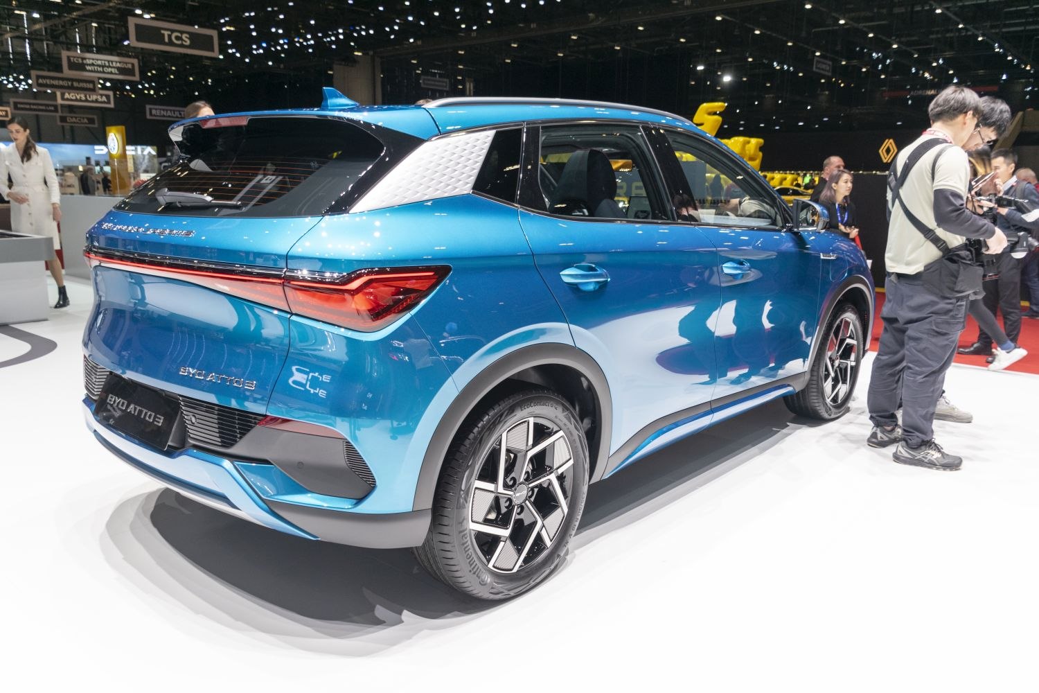 Rear and side view of a blue modern electric SUV with distinctive lighting and alloy wheels.