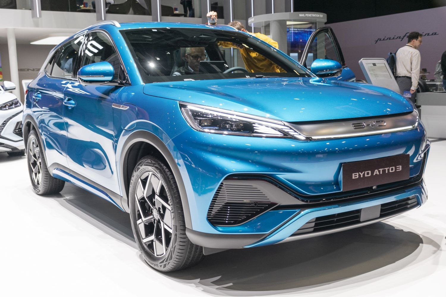 Front and side view of blue electric SUV with sleek design and modern headlights