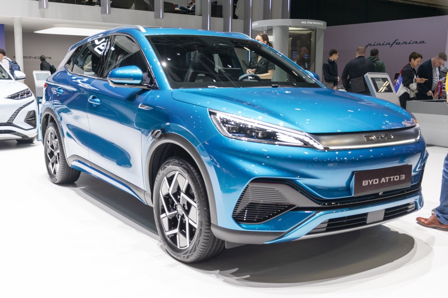 Bright blue electric SUV with sharp LED headlights and modern wheels