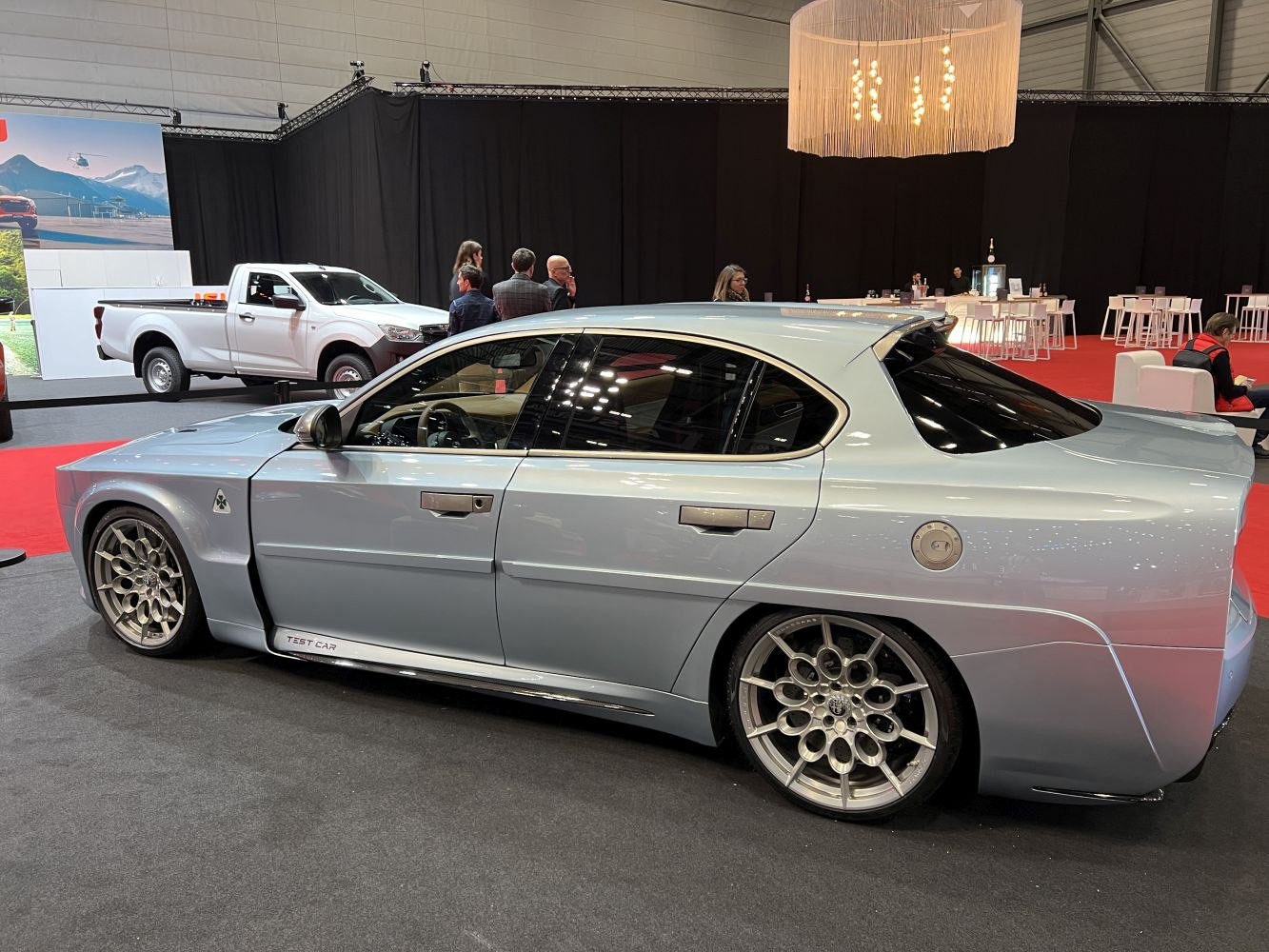 Side profile and unique multi-spoke alloy wheels of a vintage custom sedan