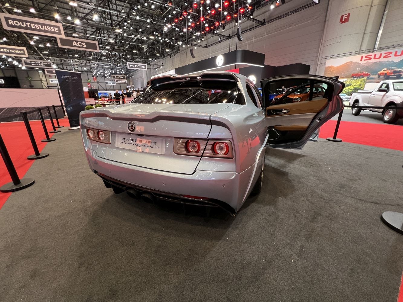 Rear view with distinctive tail lights and open rear side door