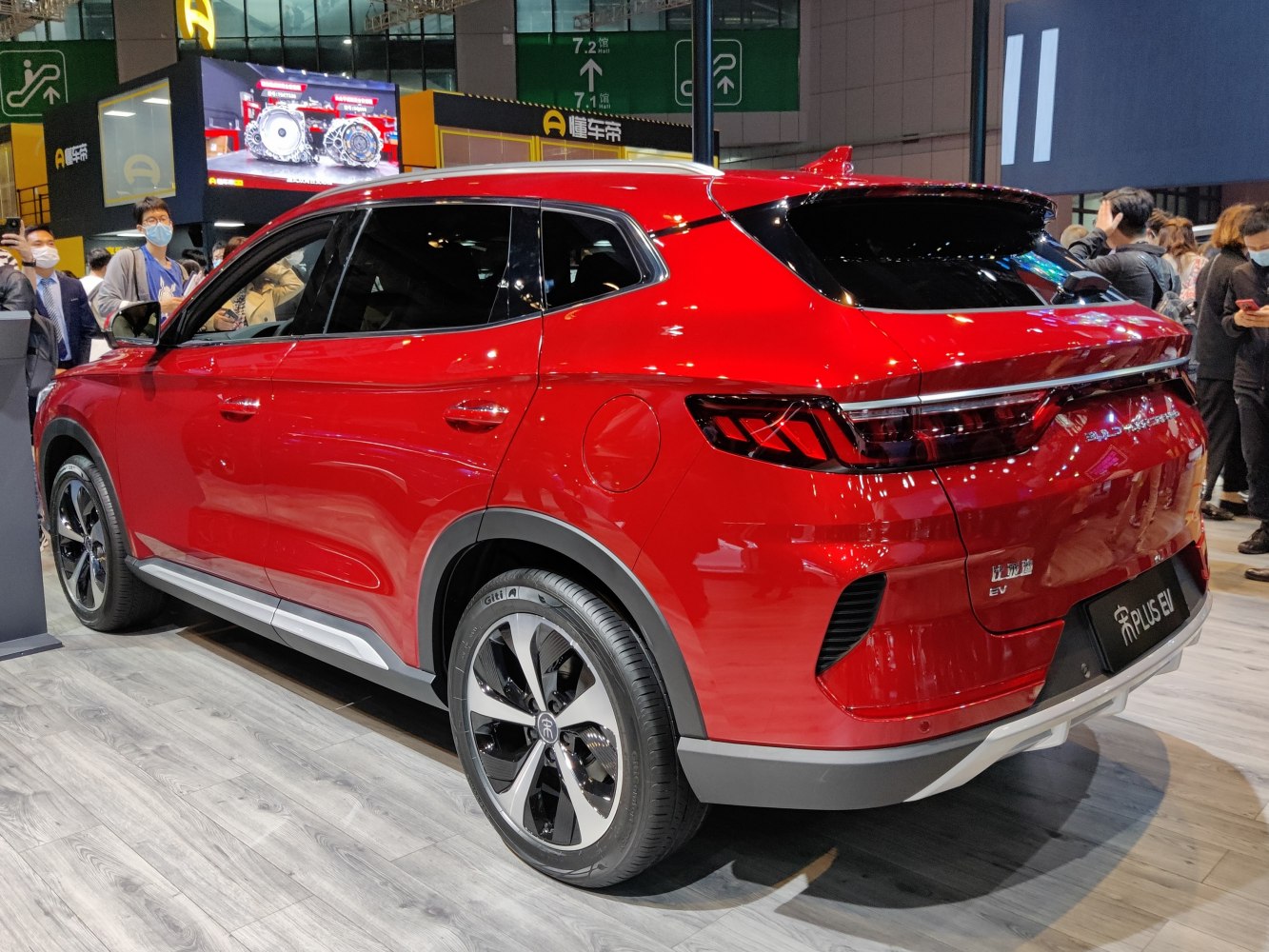 Red electric SUV rear and side view with modern tail lamps and alloy wheels.