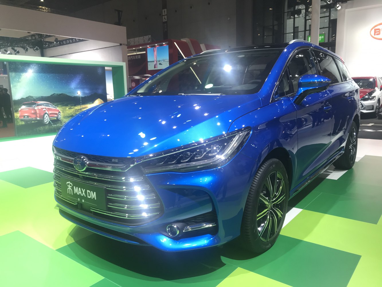Blue MPV with sleek headlights and chrome-accented grille