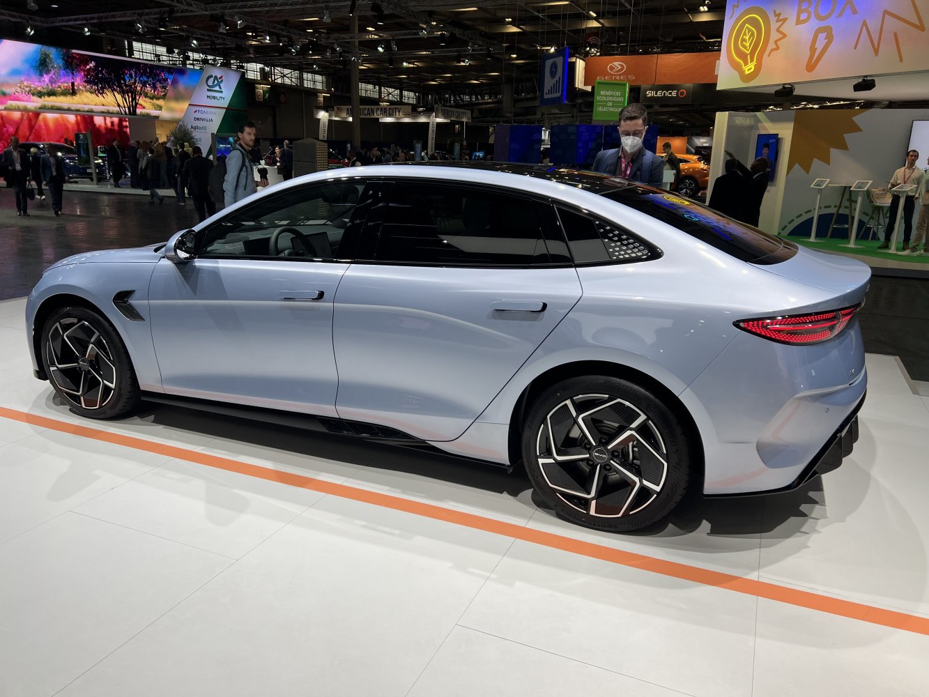 Side profile of sleek sedan with aerodynamic shape and futuristic alloy wheels